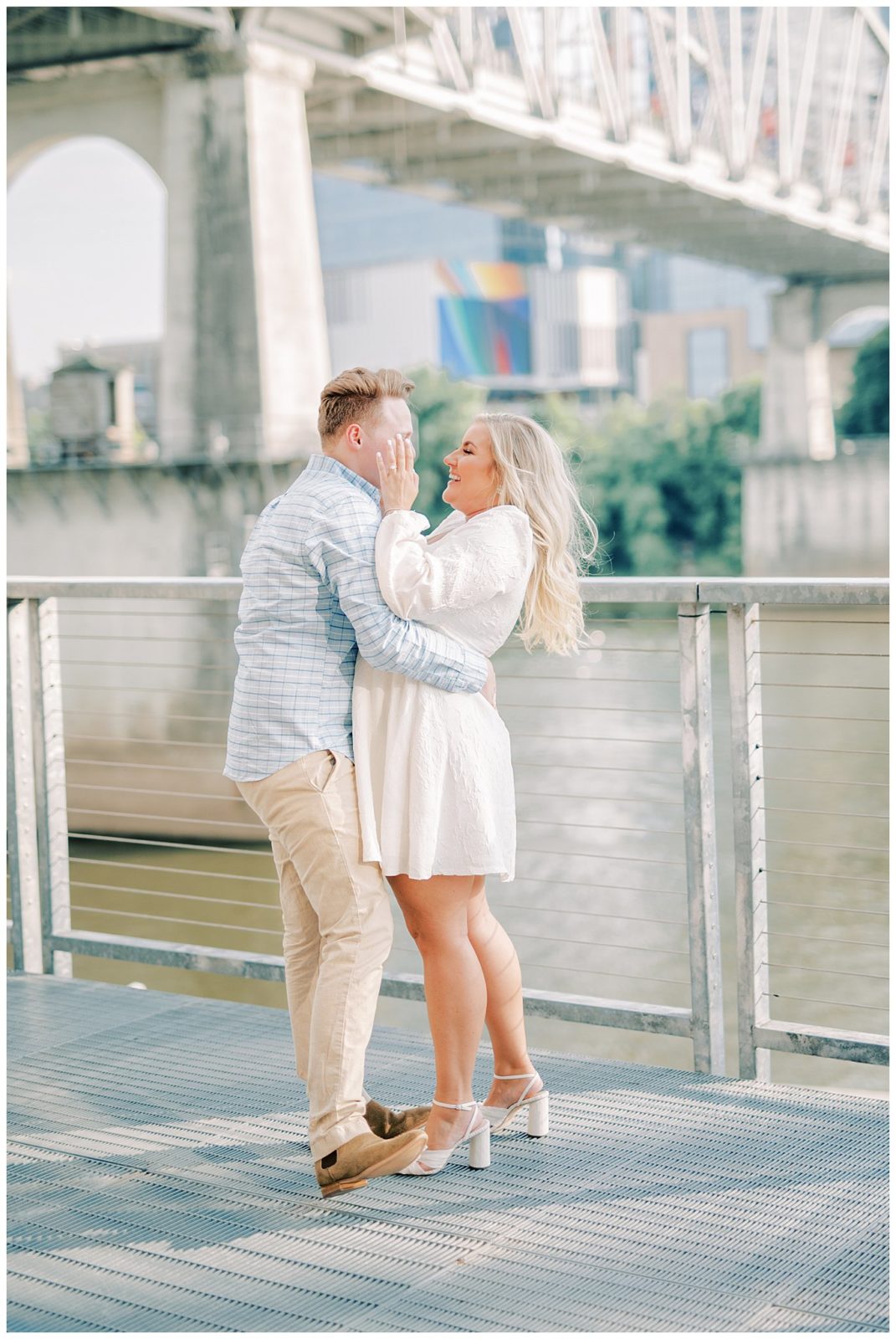 couple laughs together during engagement session in Nashville