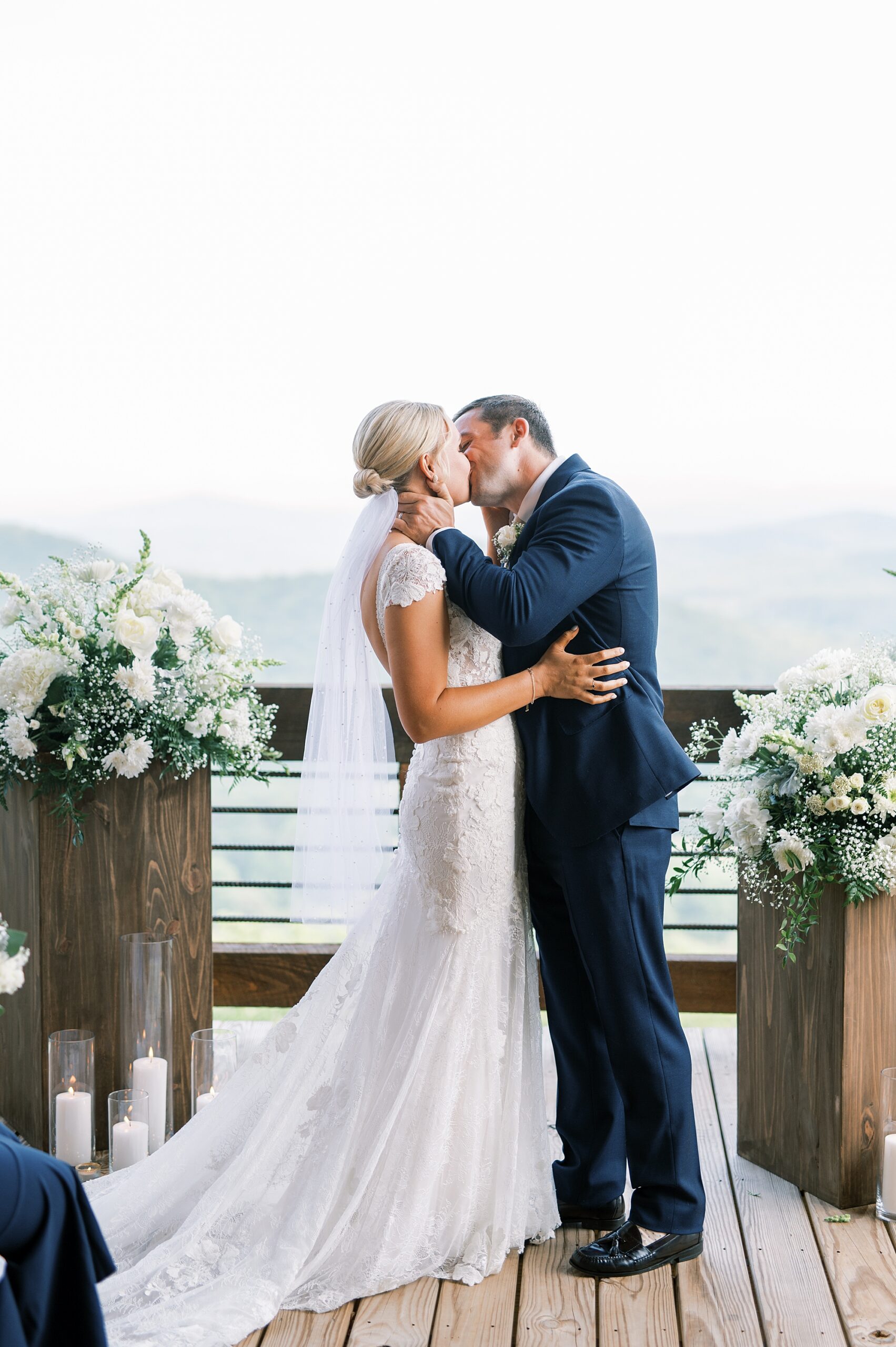 bride and groom kiss during wedding ceremony 