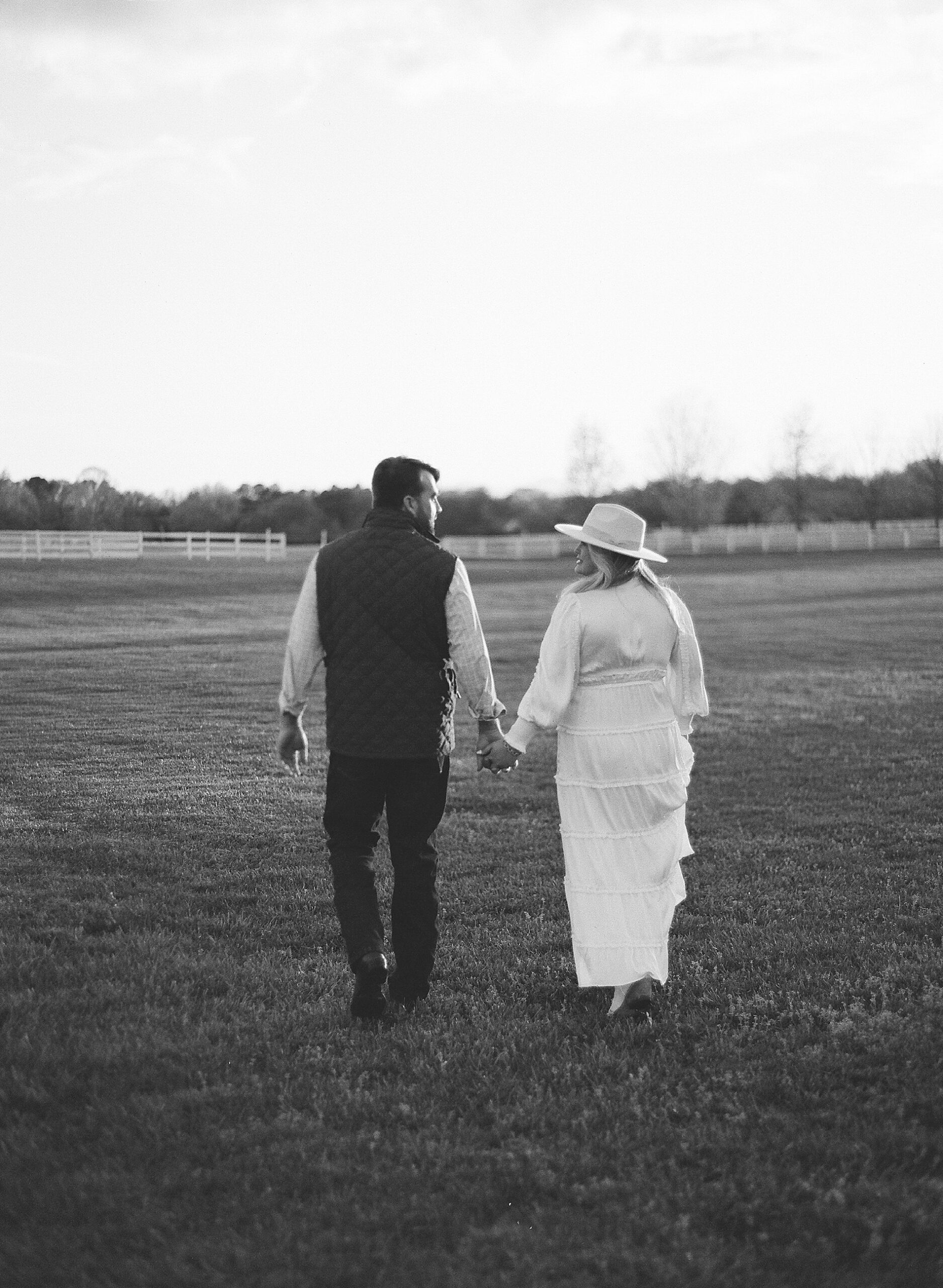 couple walk in open field 
