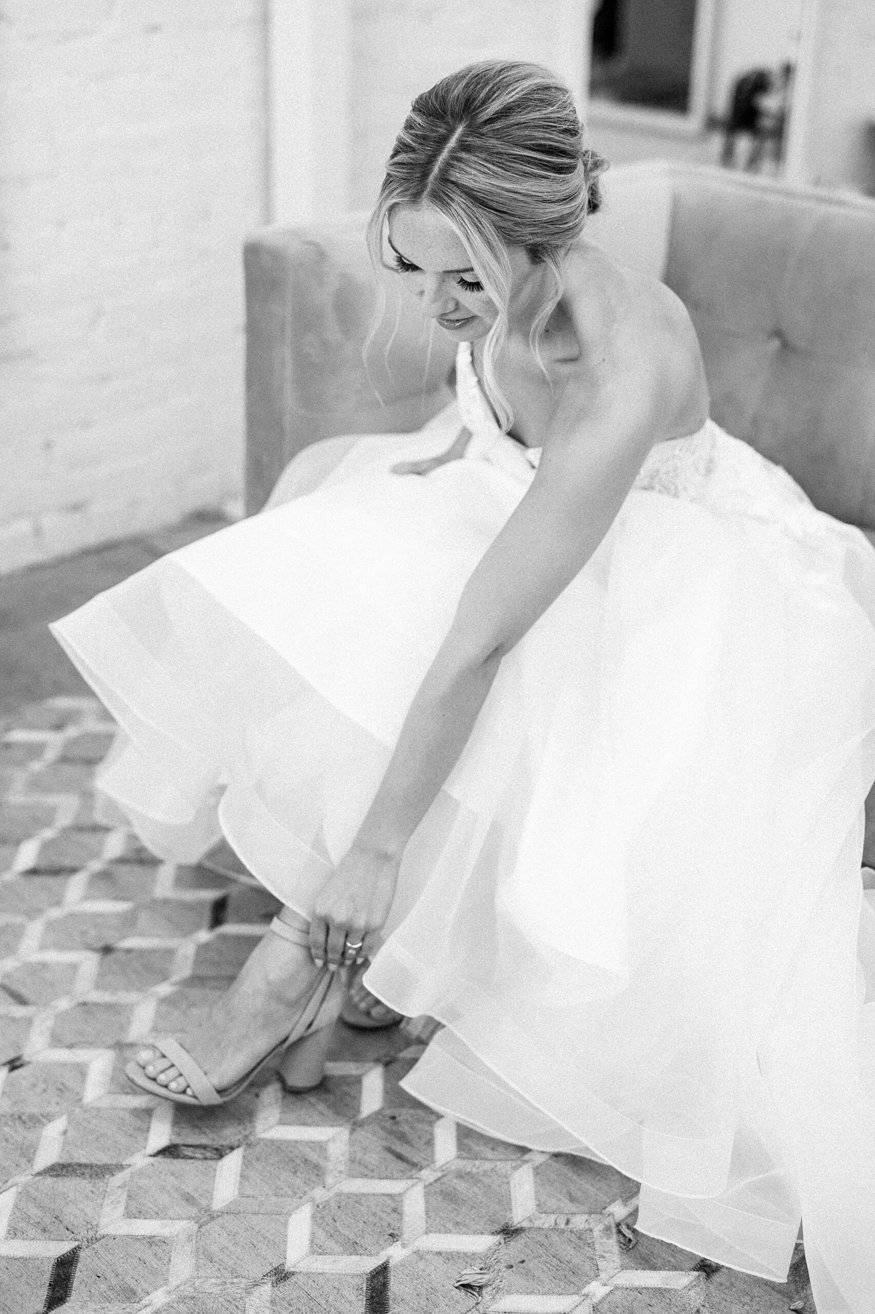 bride putting shoes on