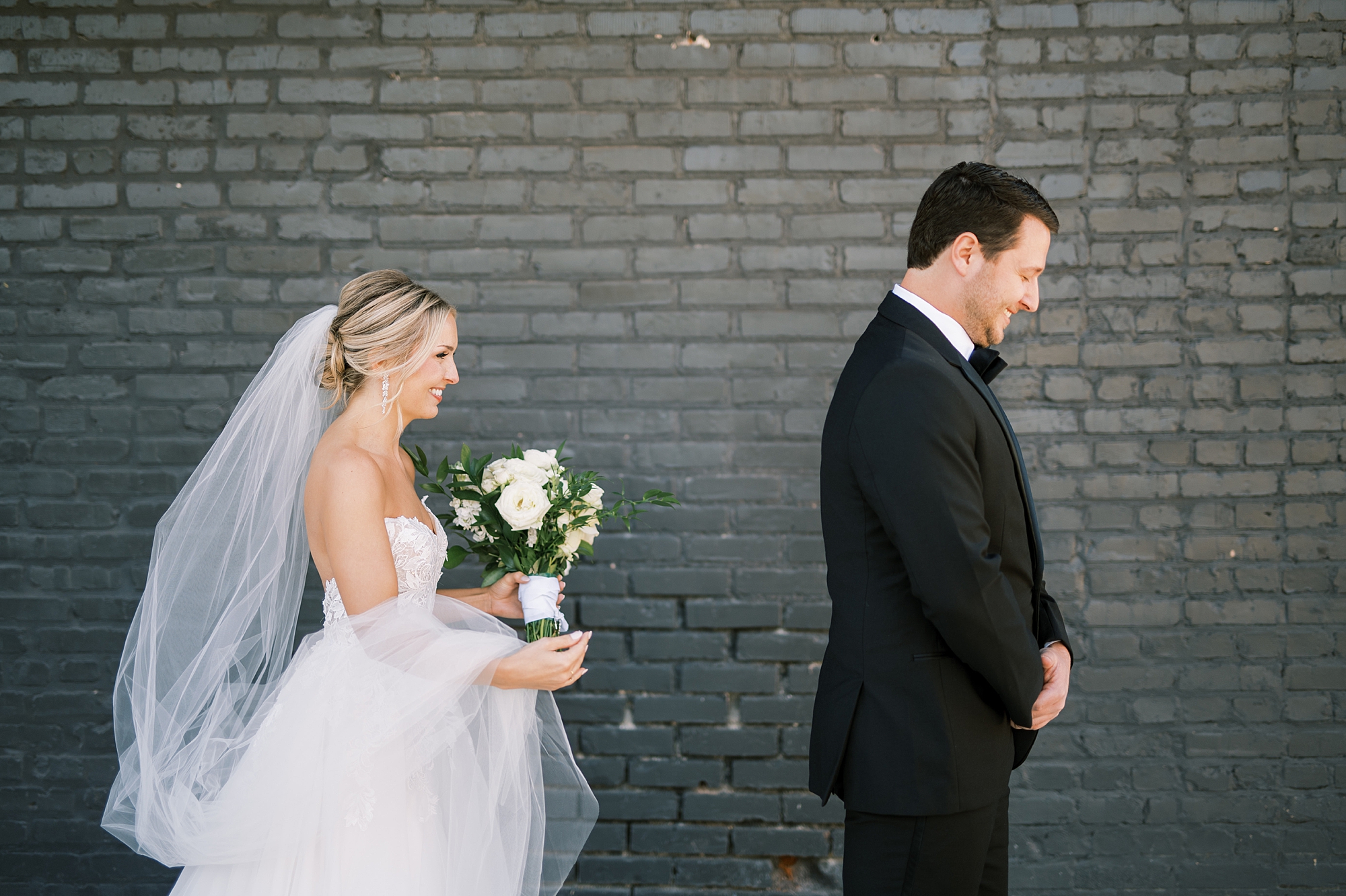 bride behind groom moments before first look