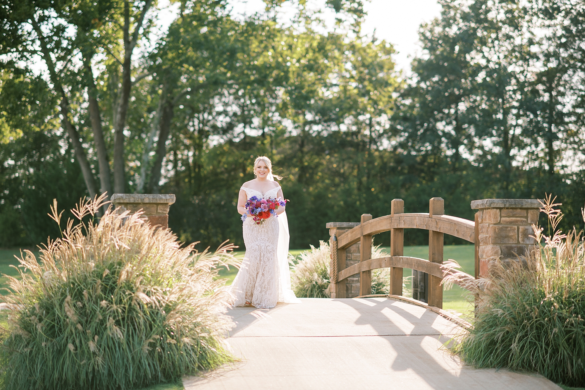 bride walks down the aisle at Elegant Magenta-Inspired Wedding at The Barn at Sycamore Farms