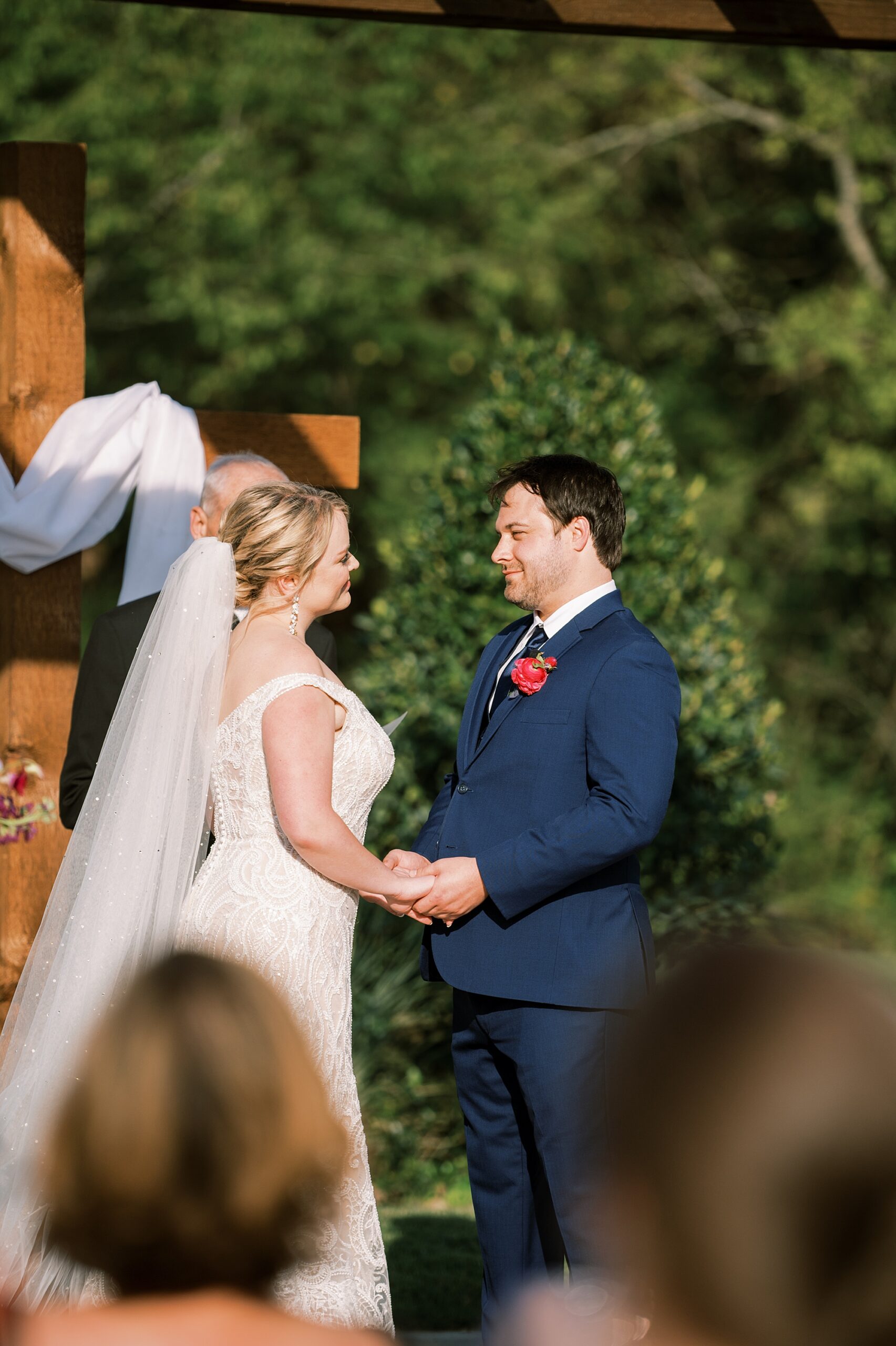 bride and groom exchange vows during outdoor ceremony 