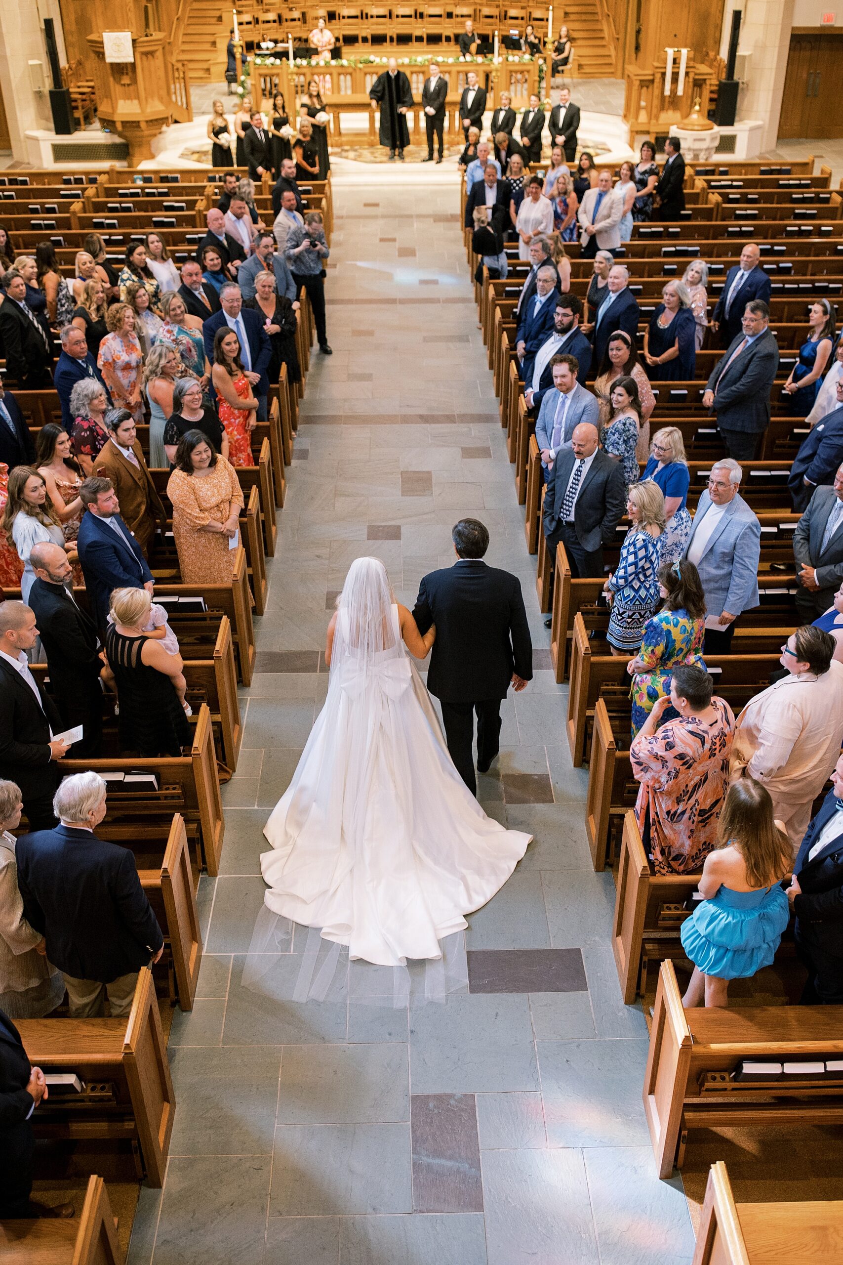 father of the bride walks daughter down the aisle 
