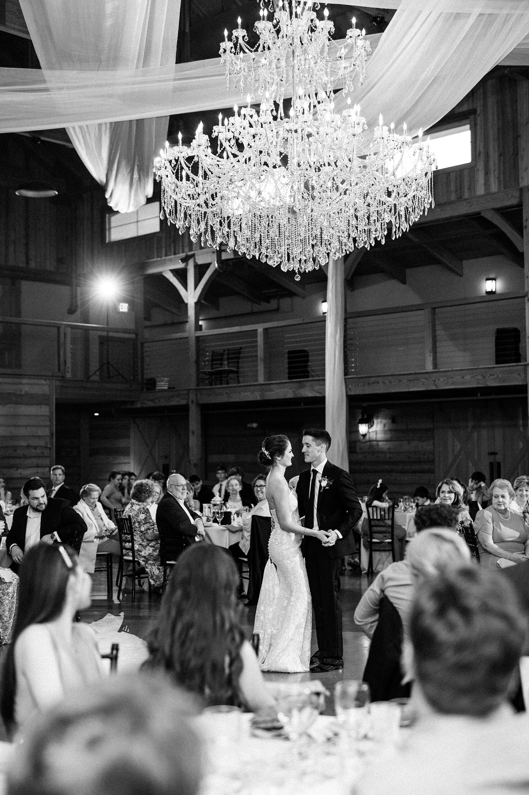newlyweds dance together at wedding reception 