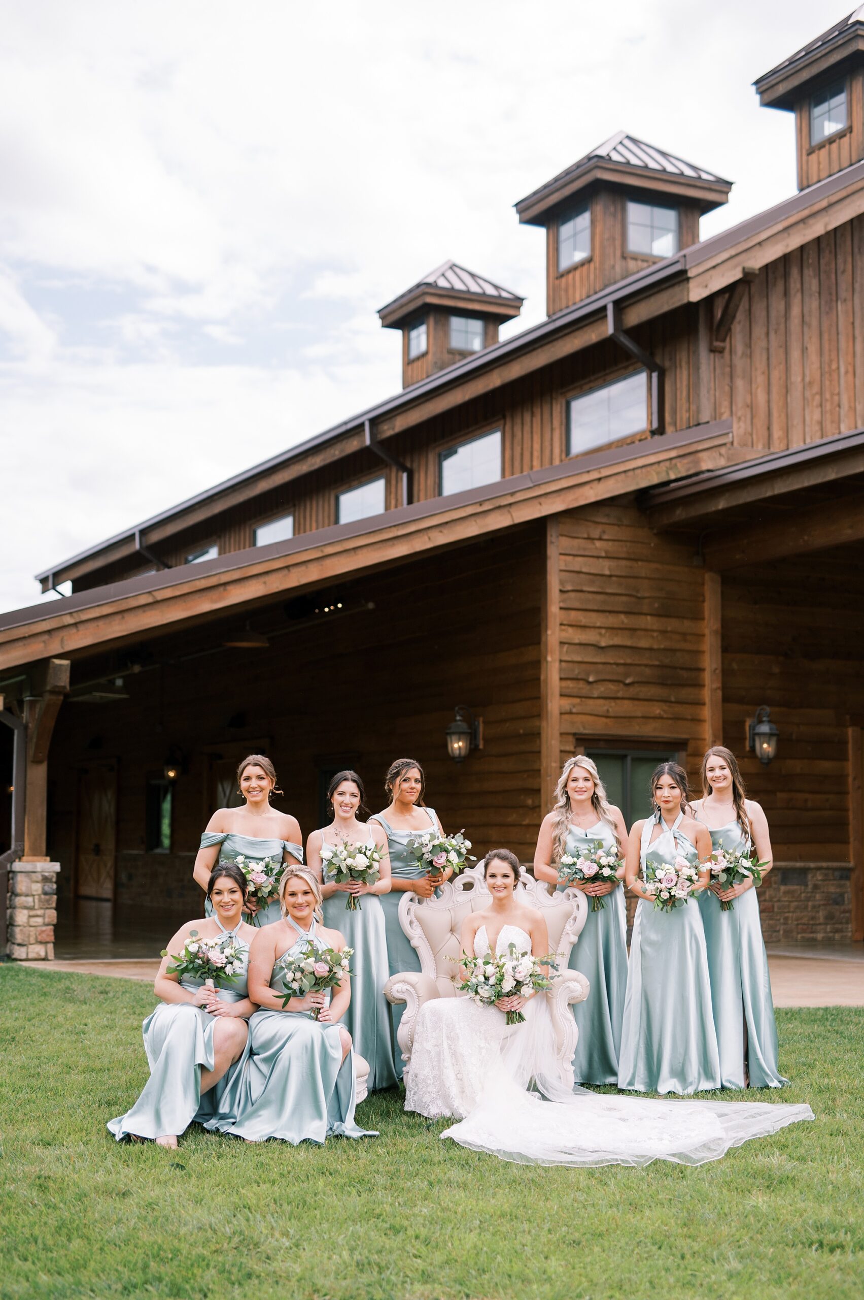 bride with bridesmaids outside of The Barn at Sycamore Farms
