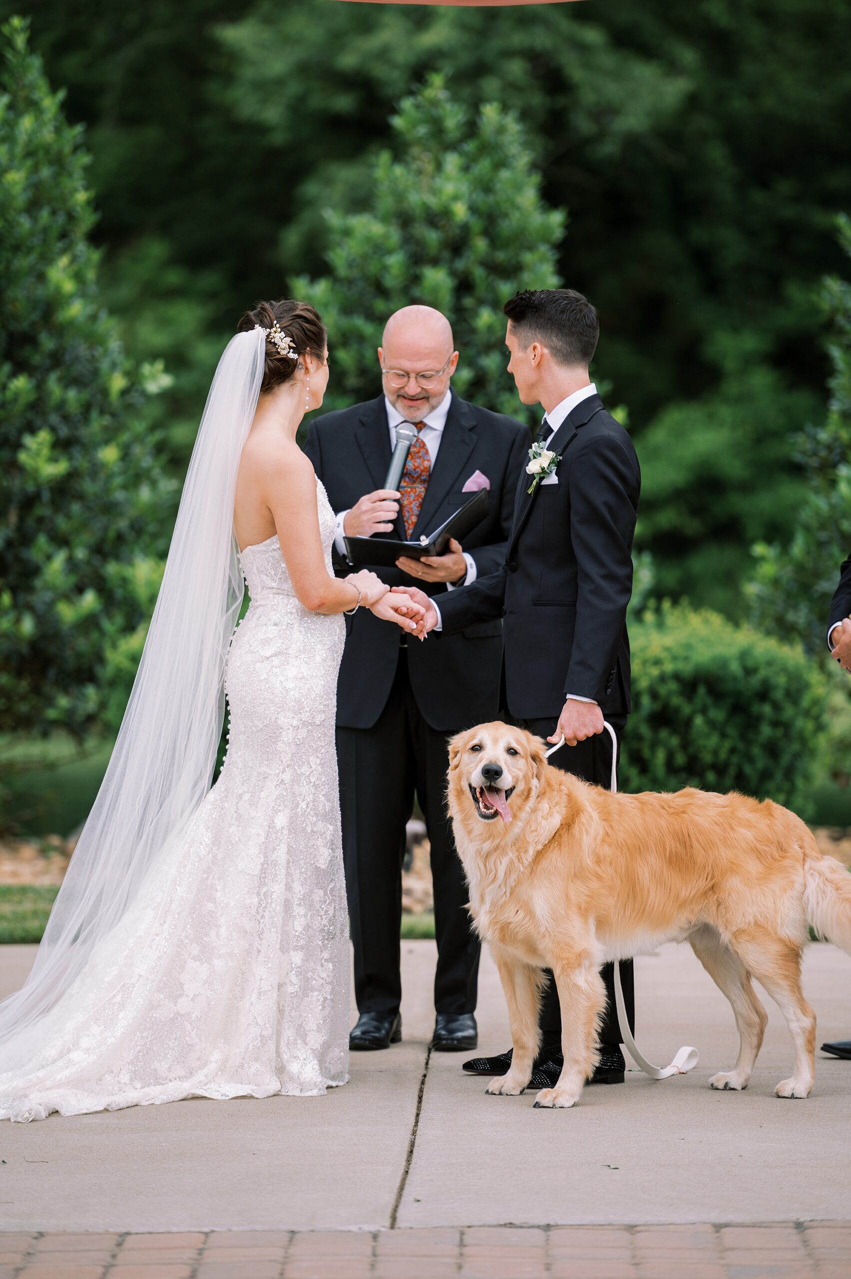 couple exchange vows with their dog next to them