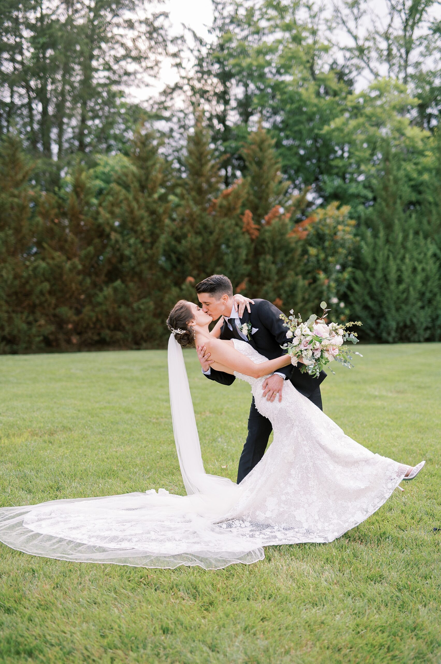 groom dips and kisses his bride 