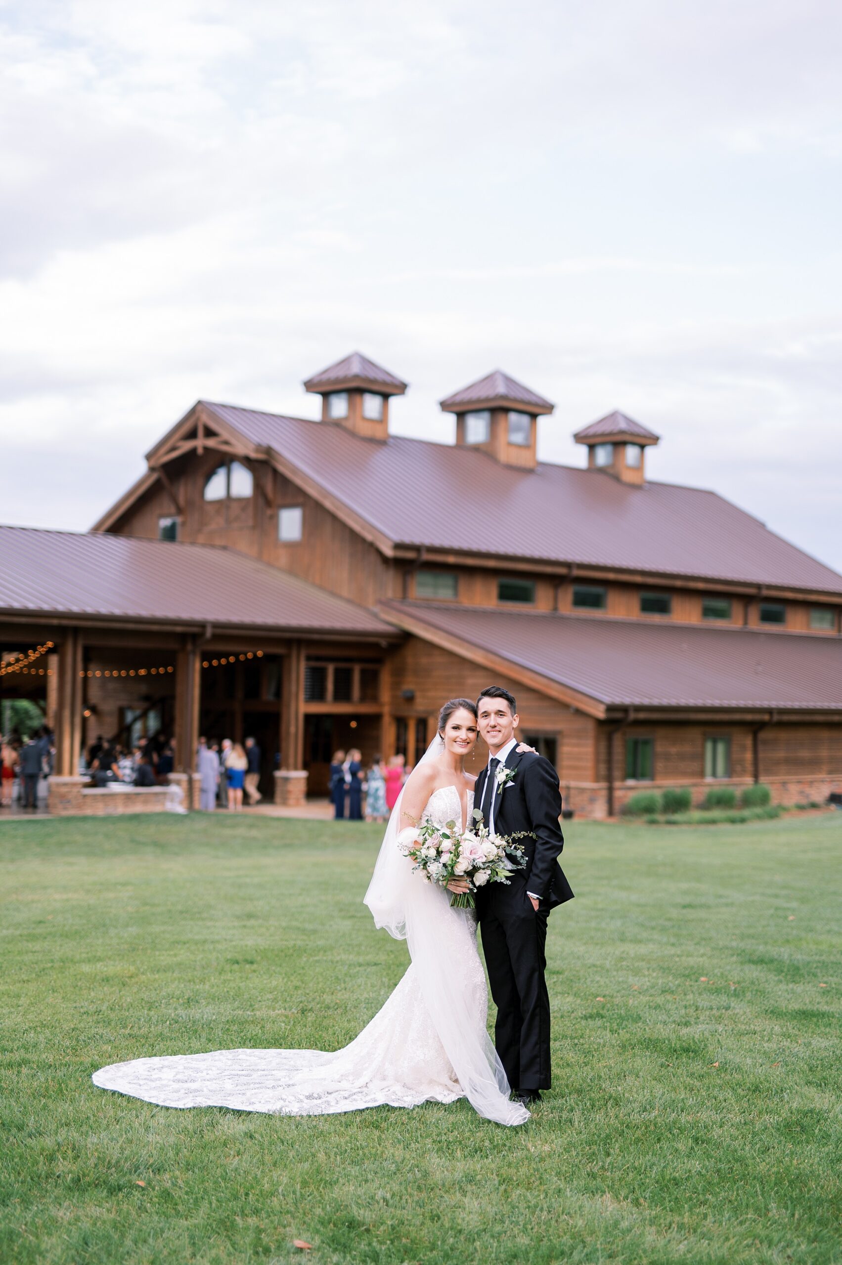bride and groom outside of The Barn at Sycamore Farms from Dreamy Summer Wedding