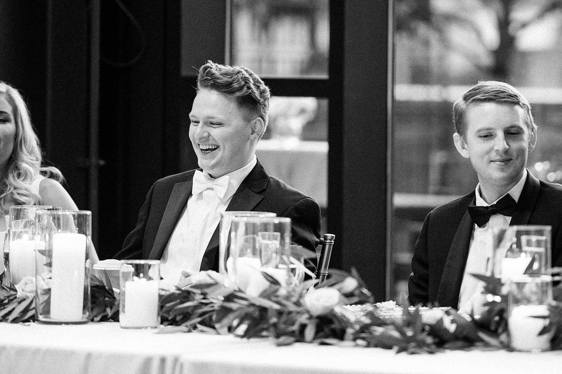 groom laughs during wedding toasts