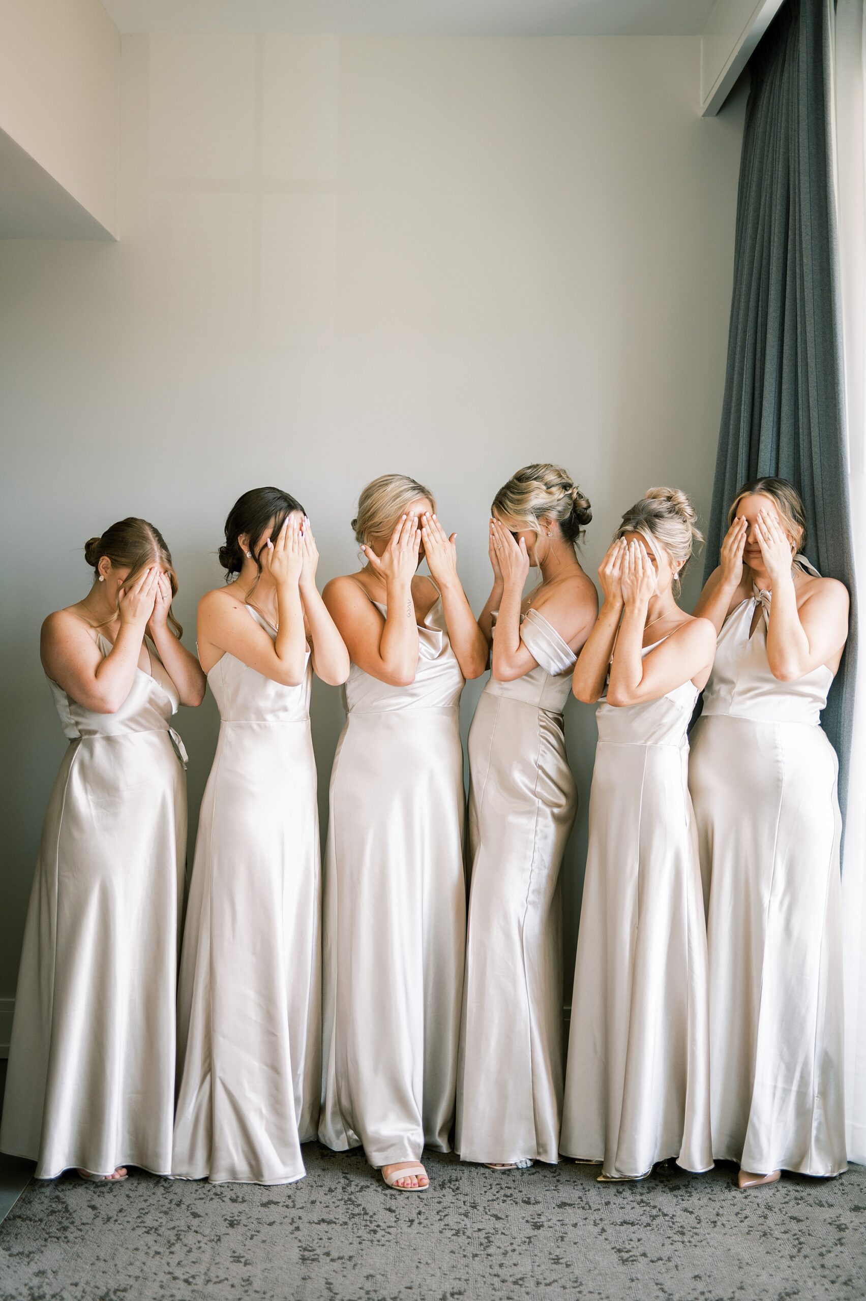 bridesmaids cover eyes before first look with bride