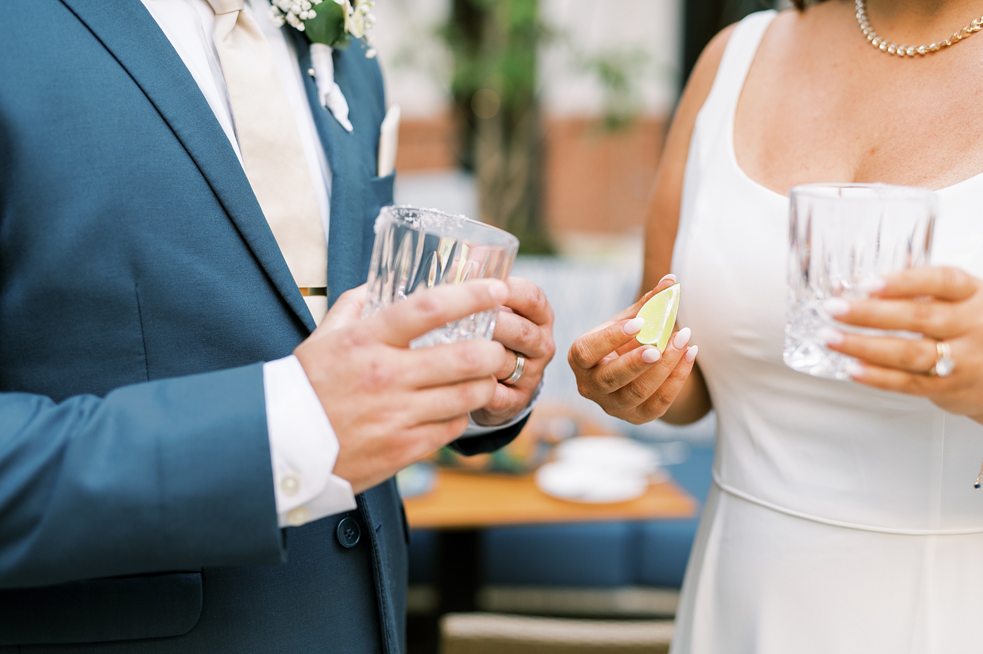 newlyweds share drink after wedding