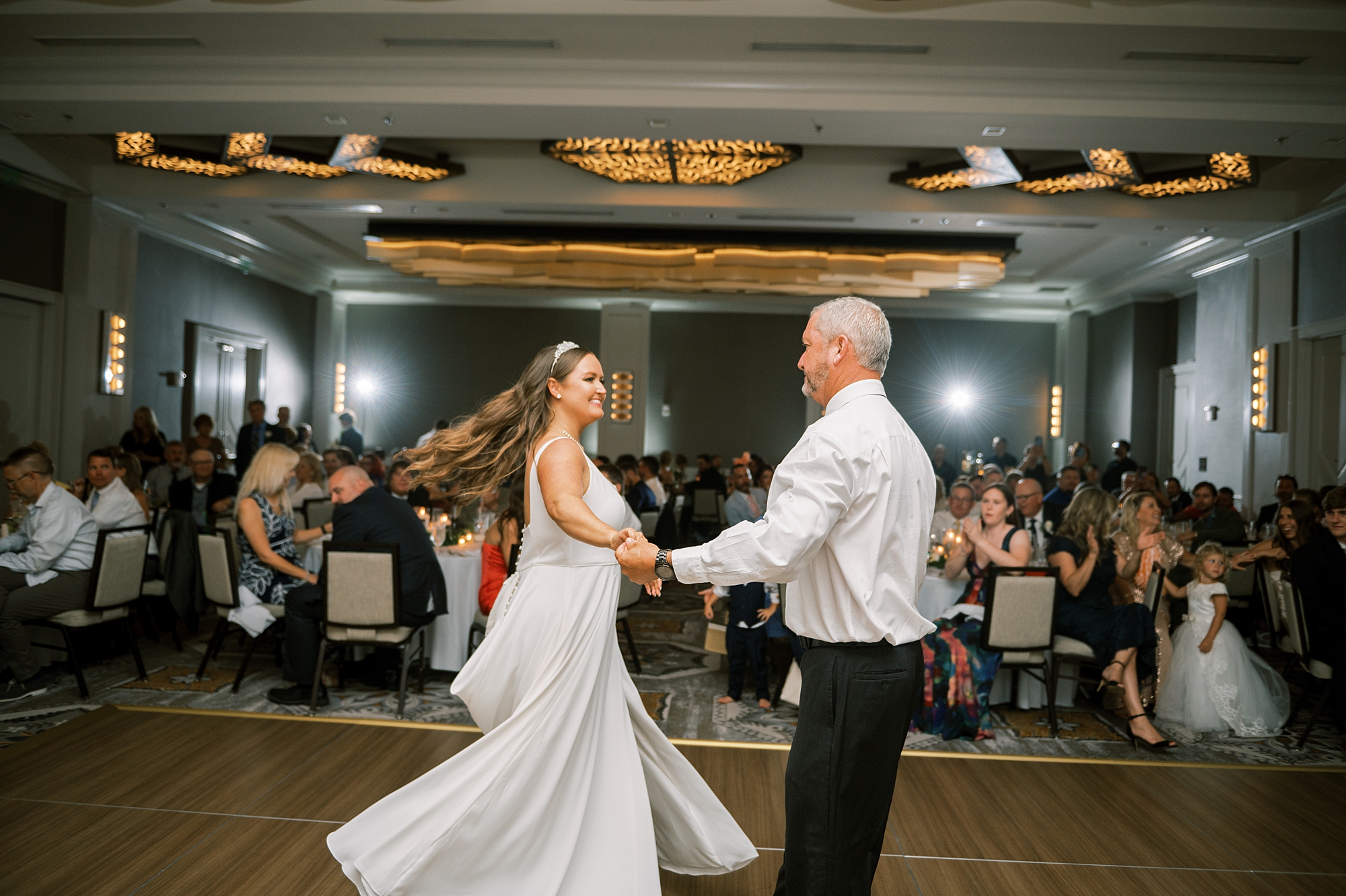 dad spins his daughter around during father daughter dance at Timeless Downtown Franklin Wedding at Harpeth Hotel 