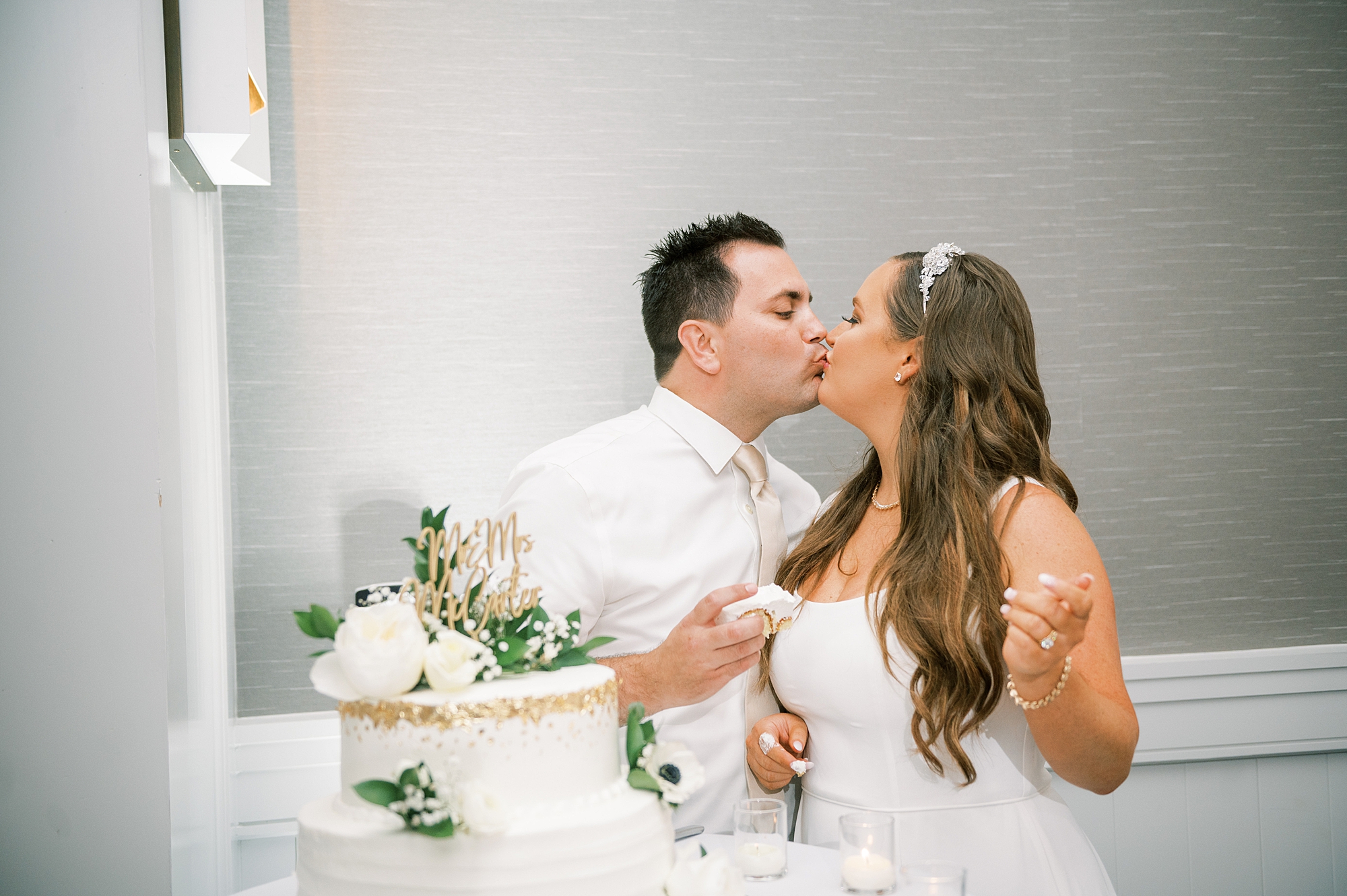 newlyweds kiss during cake cutting at  Timeless Downtown Franklin Wedding at Harpeth Hotel 