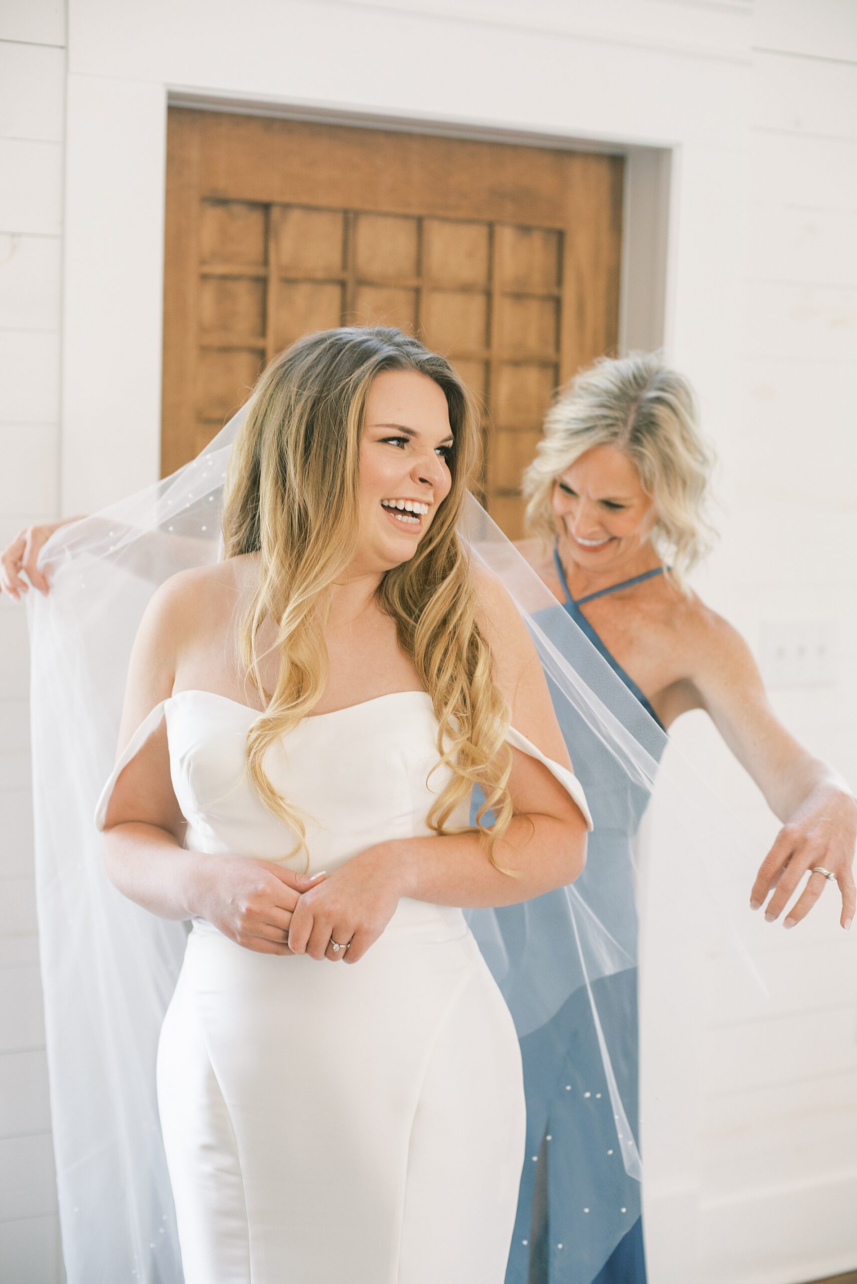 mom helps daughter with veil before Southern Harvest Hollow Wedding