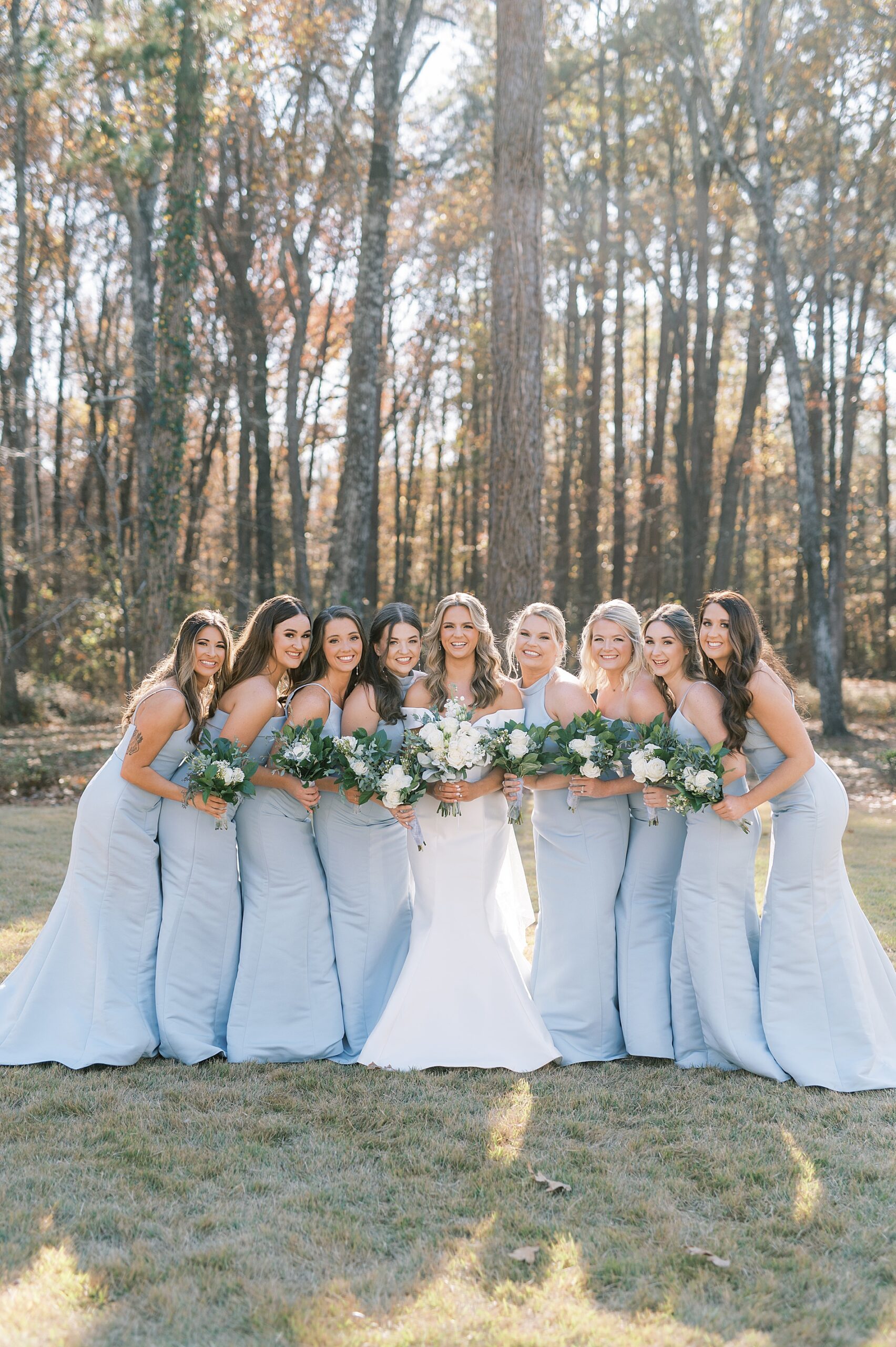 bridesmaids in dusty blue dresses with bride