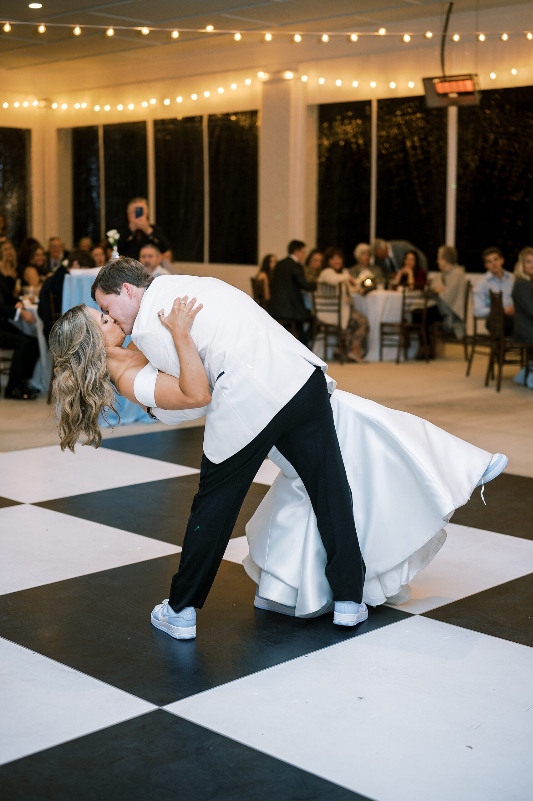 groom dips bride on the dance floor