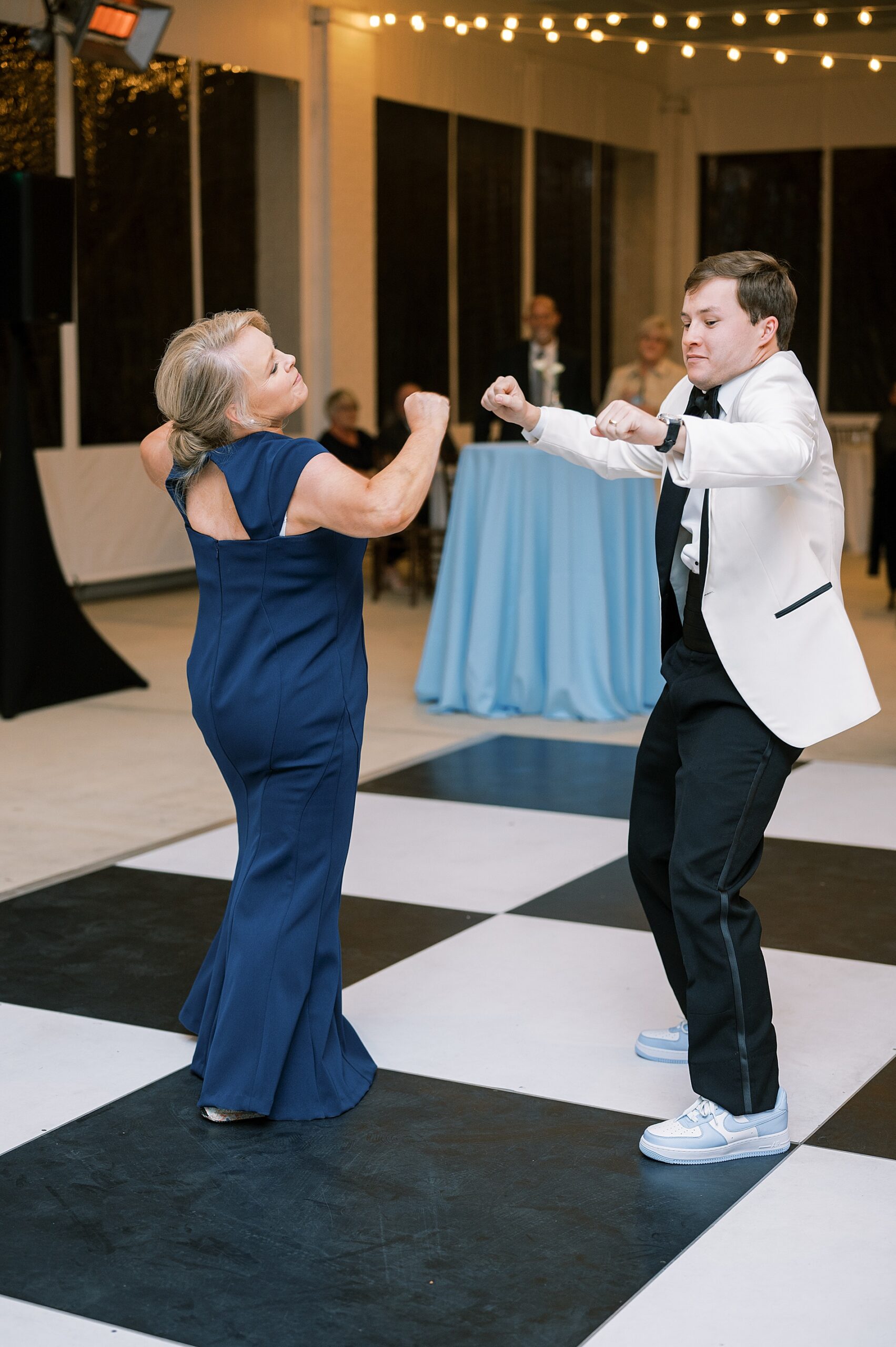 candid portraits of groom and mother on the dance floor
