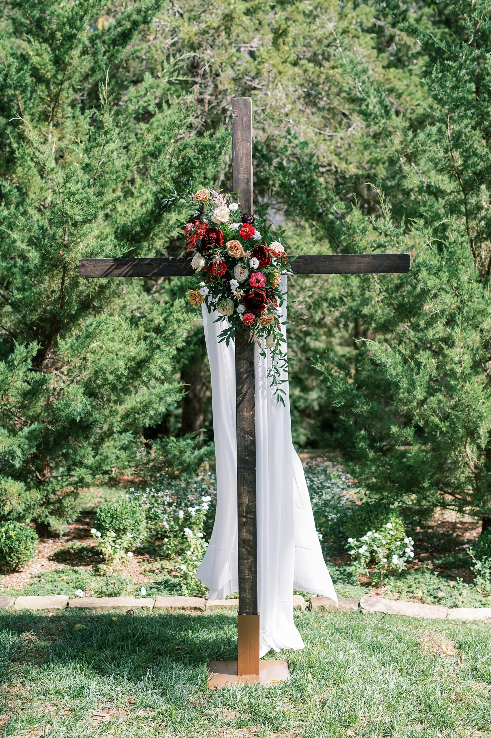cross decorated with wedding flowers from Franklin TN Wedding at Cedarmont Farm