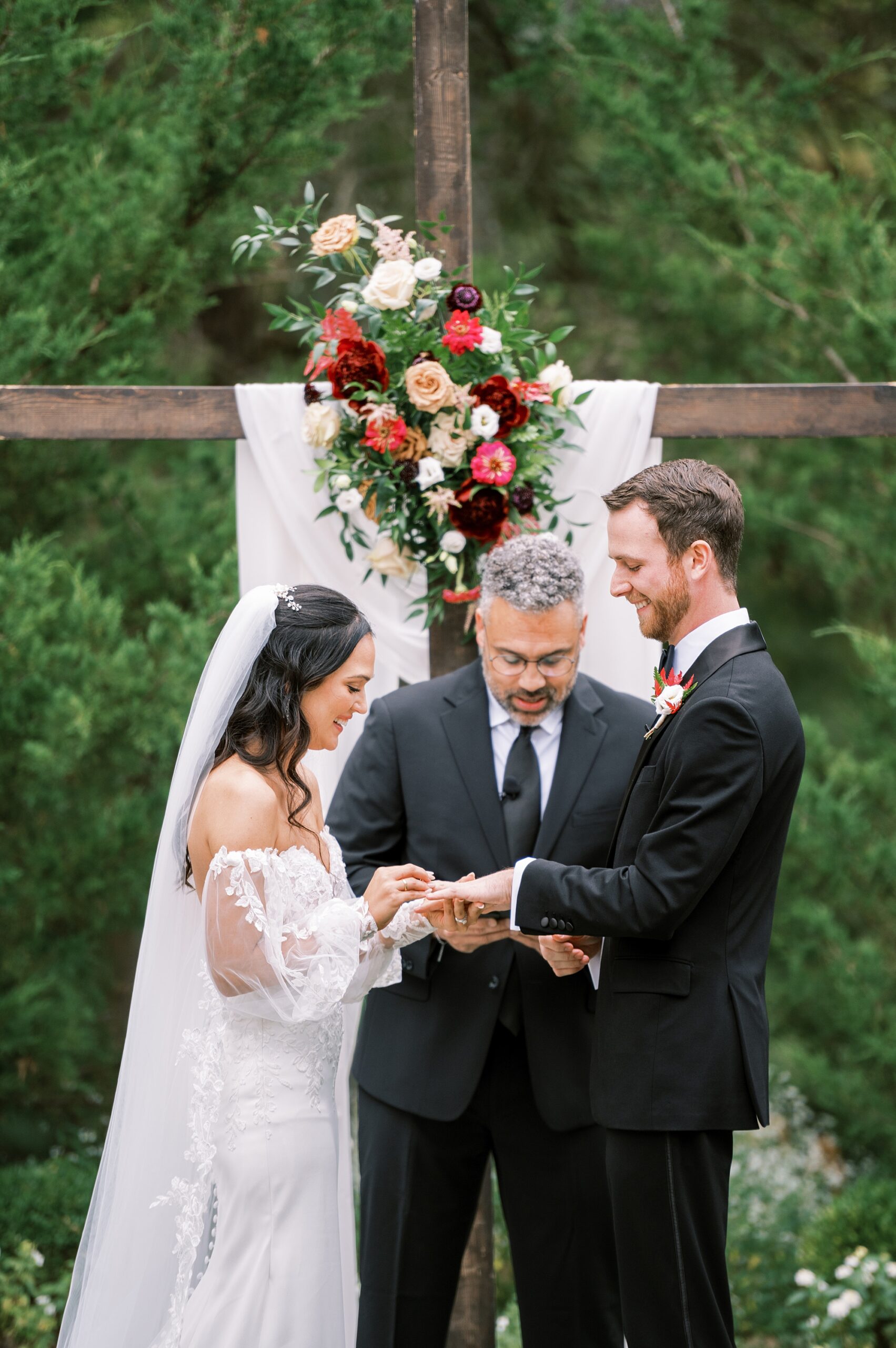 bride puts ring on groom's finger