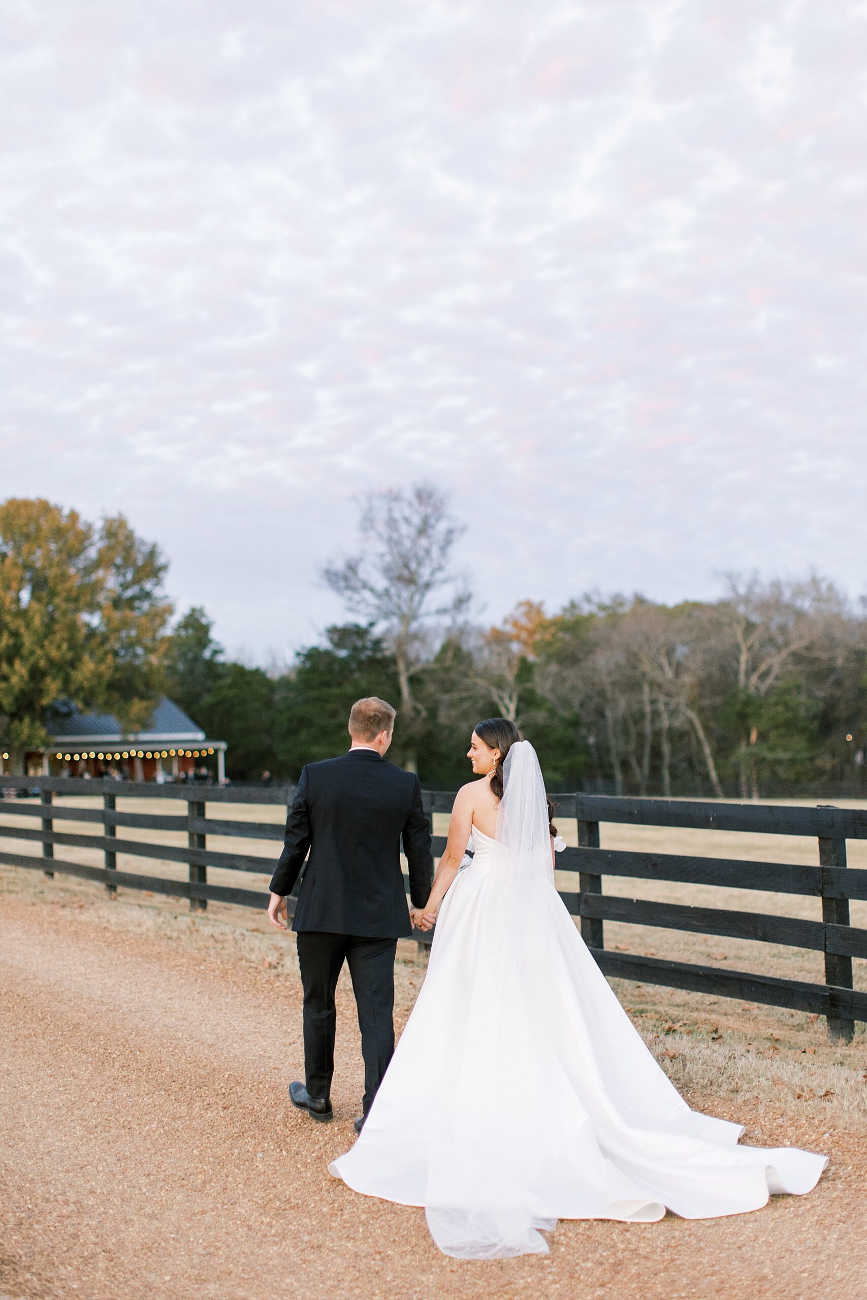 newlyweds walk down path at Cedarmont Farm