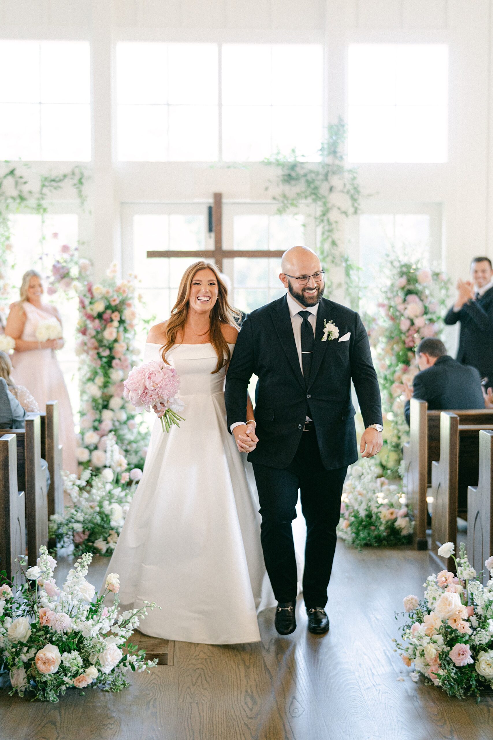 newlyweds exit wedding ceremony at Venue At Birchwood