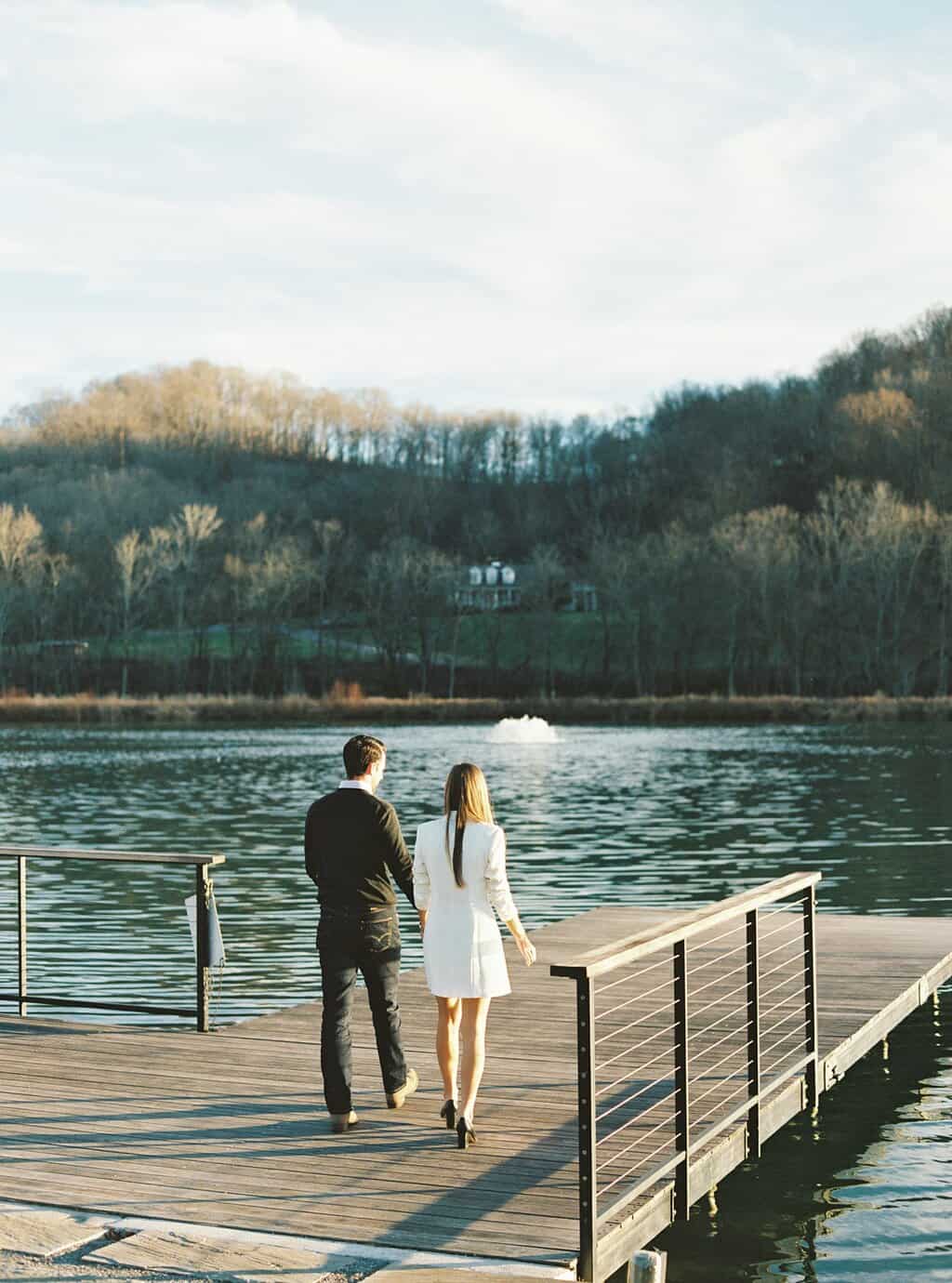 couple walk out on dock by the water at Southall Farm & Inn