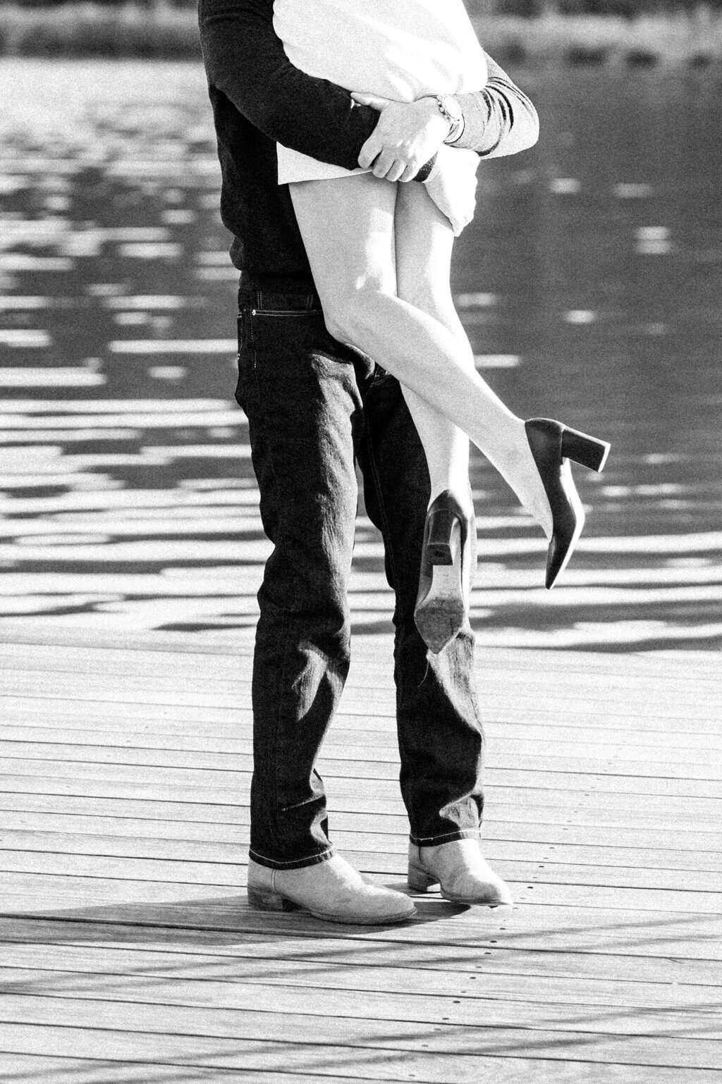 guy lifts fiancé up in his arms