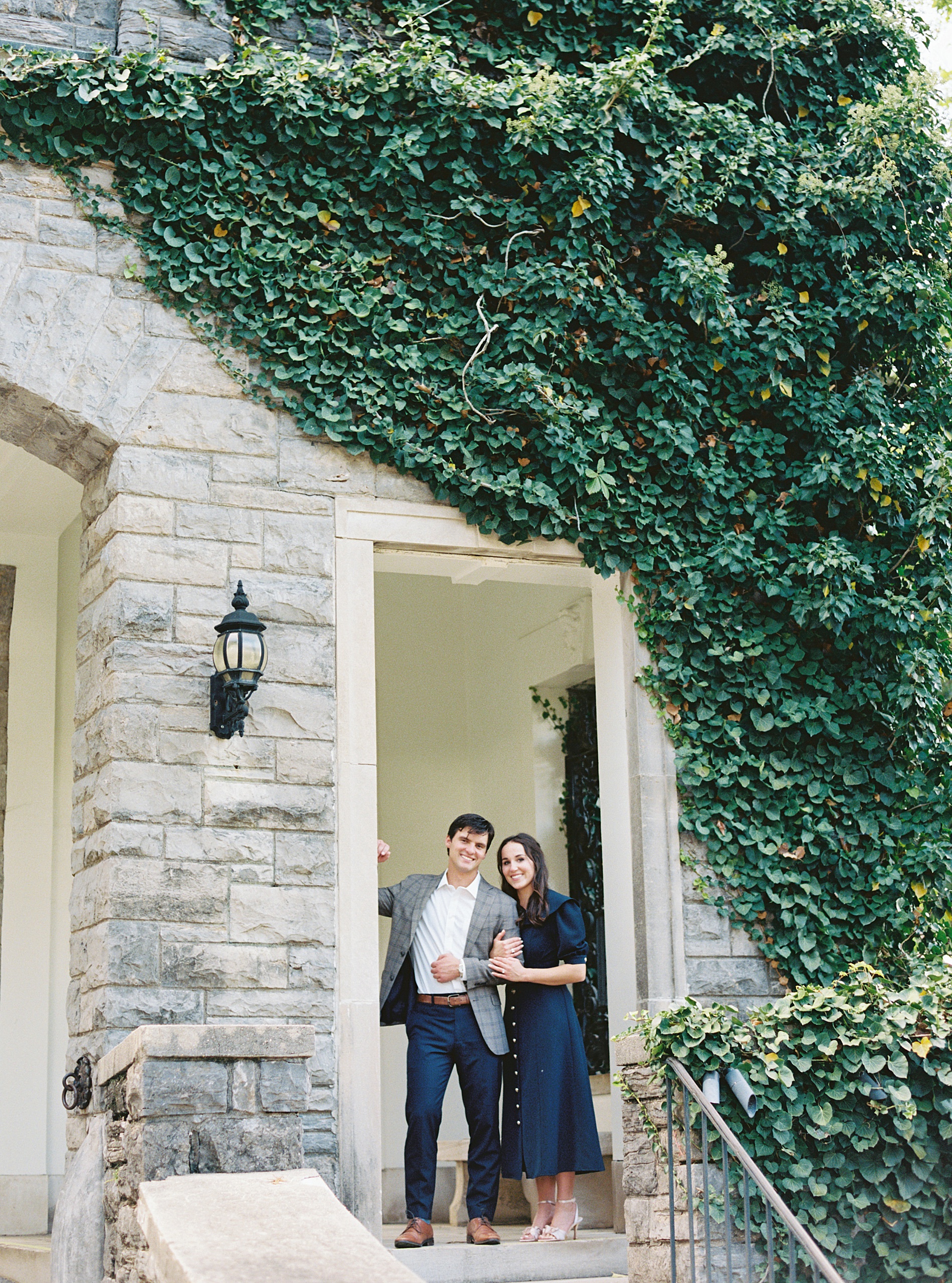 engaged couple in doorway of building