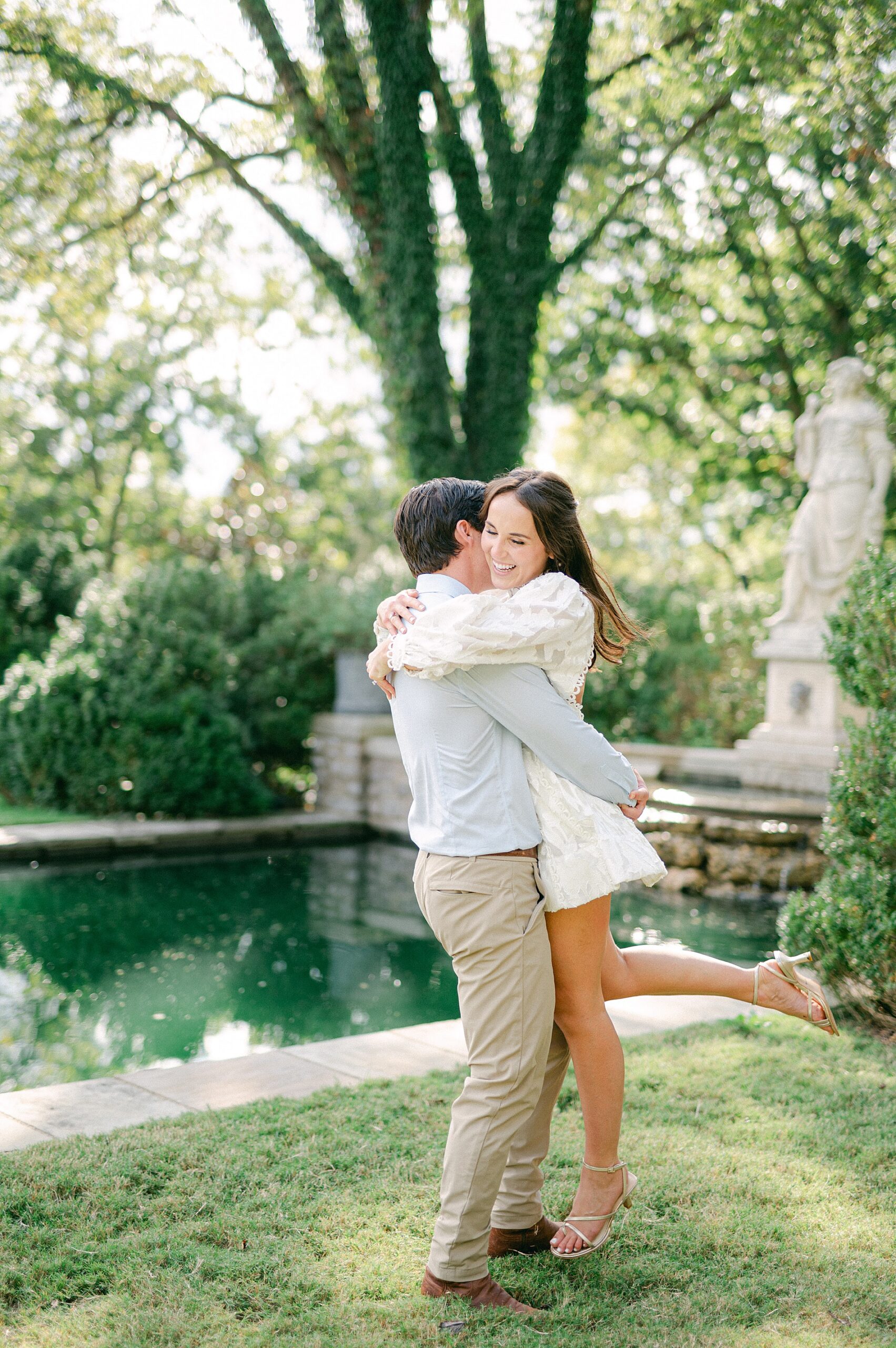 romantic and joyful engagement photos of couple by reflection pool at Cheekwood Estate and Gardens