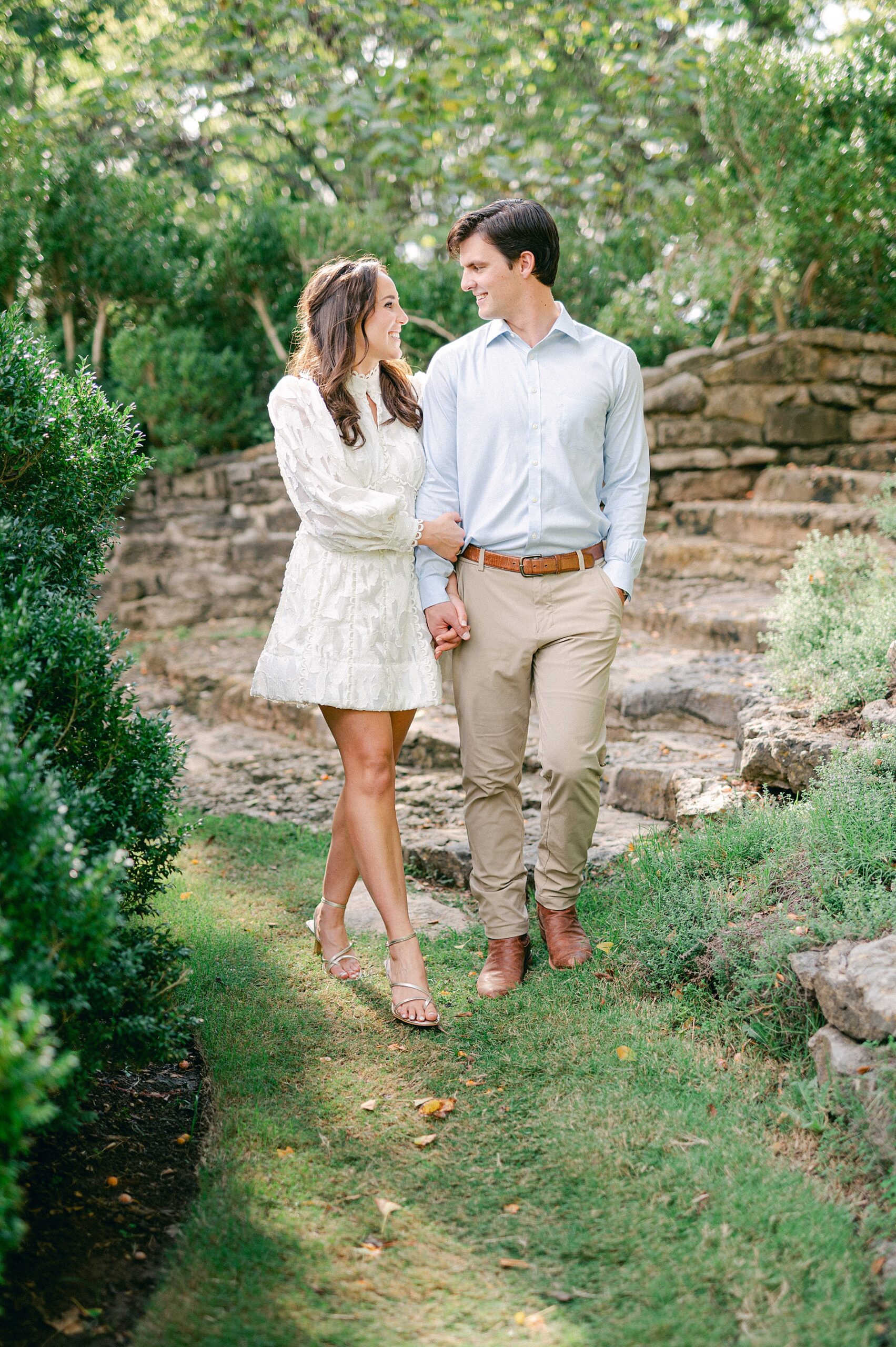 couple walk down stone pathway during Nashville Engagement