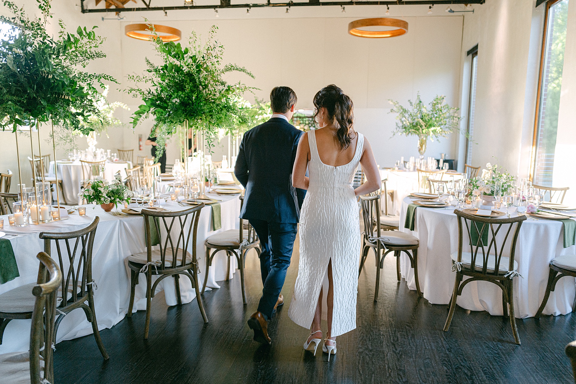 couple walk through rehearsal dinner space and take in all the details 
