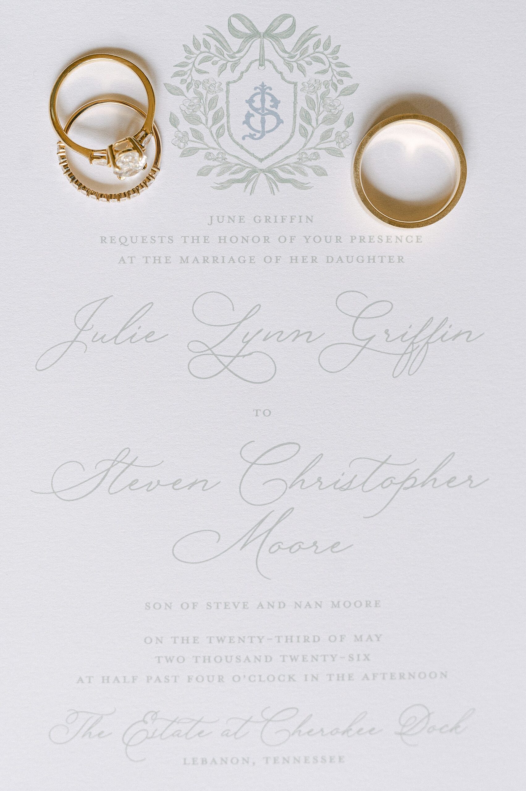 wedding rings on white invitation