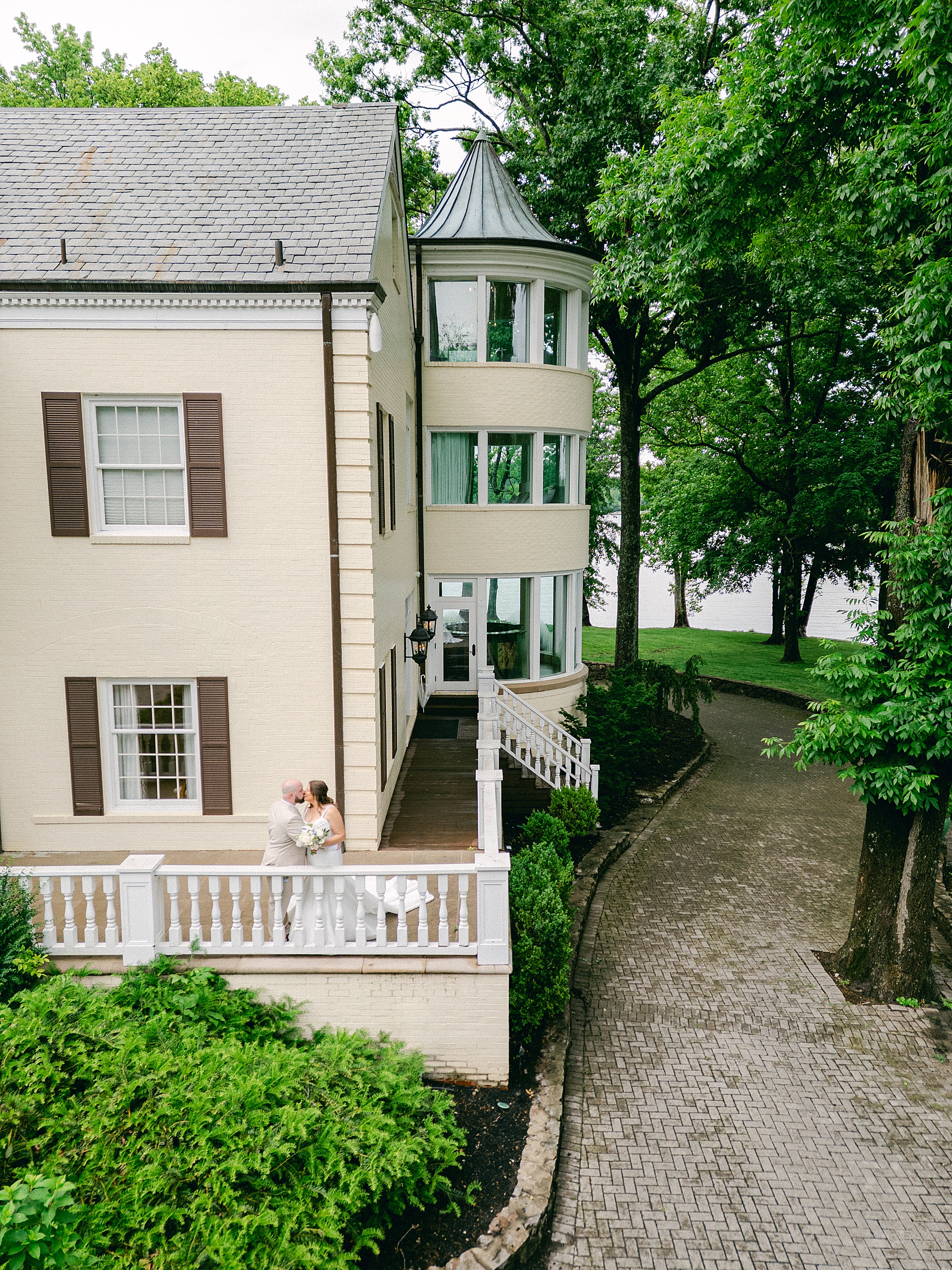bride and groom portraits on porch of The Estate at Cherokee Dock