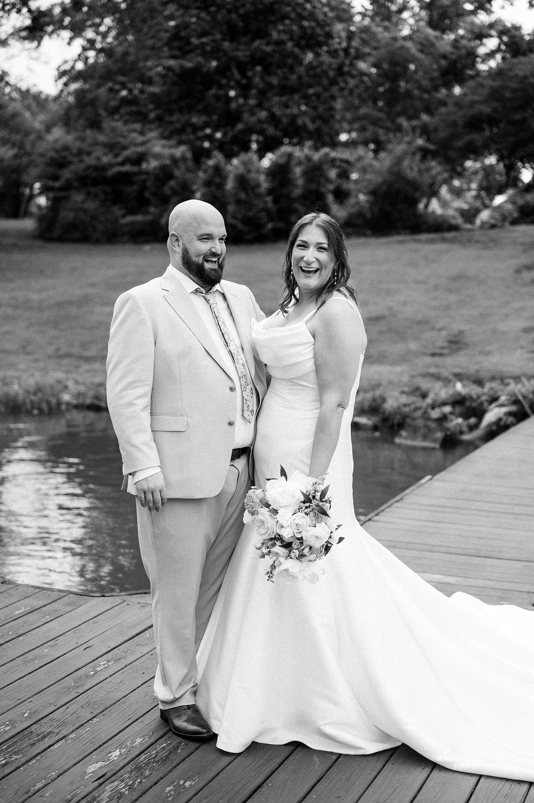 candid bride and groom portraits by the water