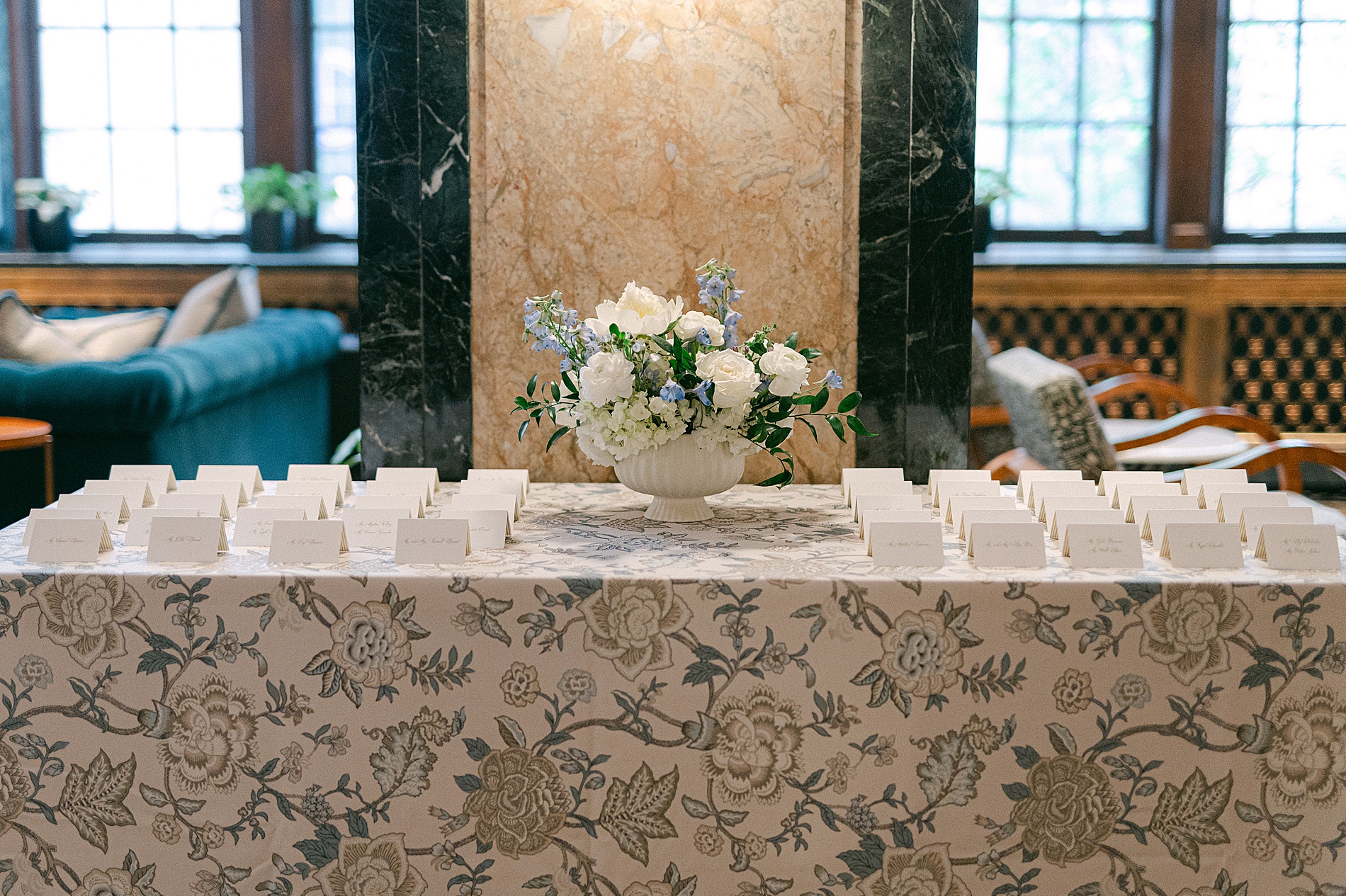patterned tablecloths with place cards arranged for guests seating arrangement