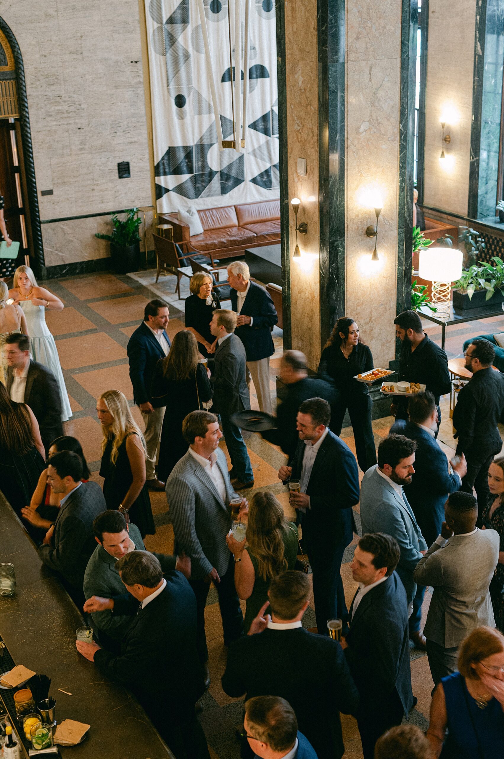 guests mingle at Noelle Hotel in downtown Nashville for rehearsal dinner