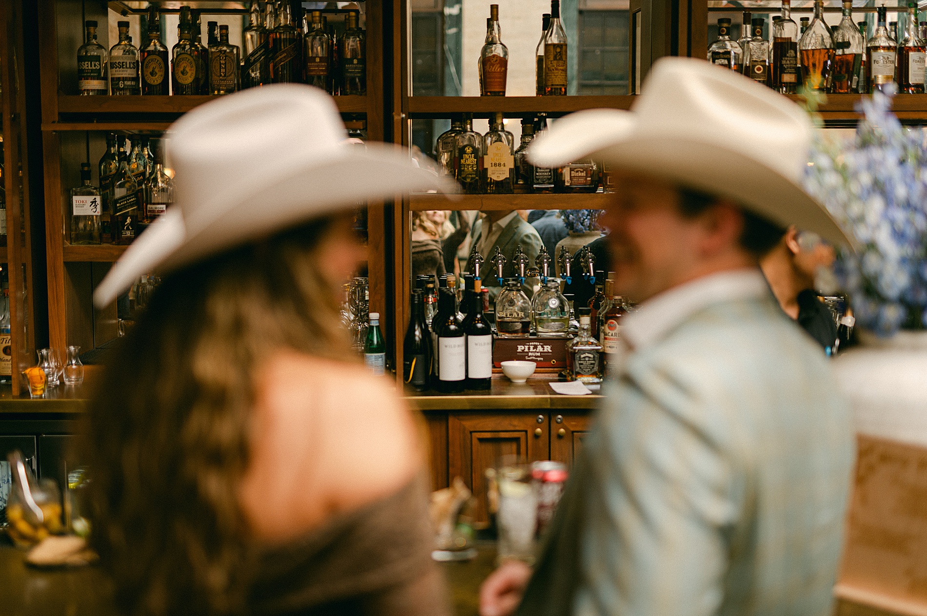 guests in cowboy hats at bar