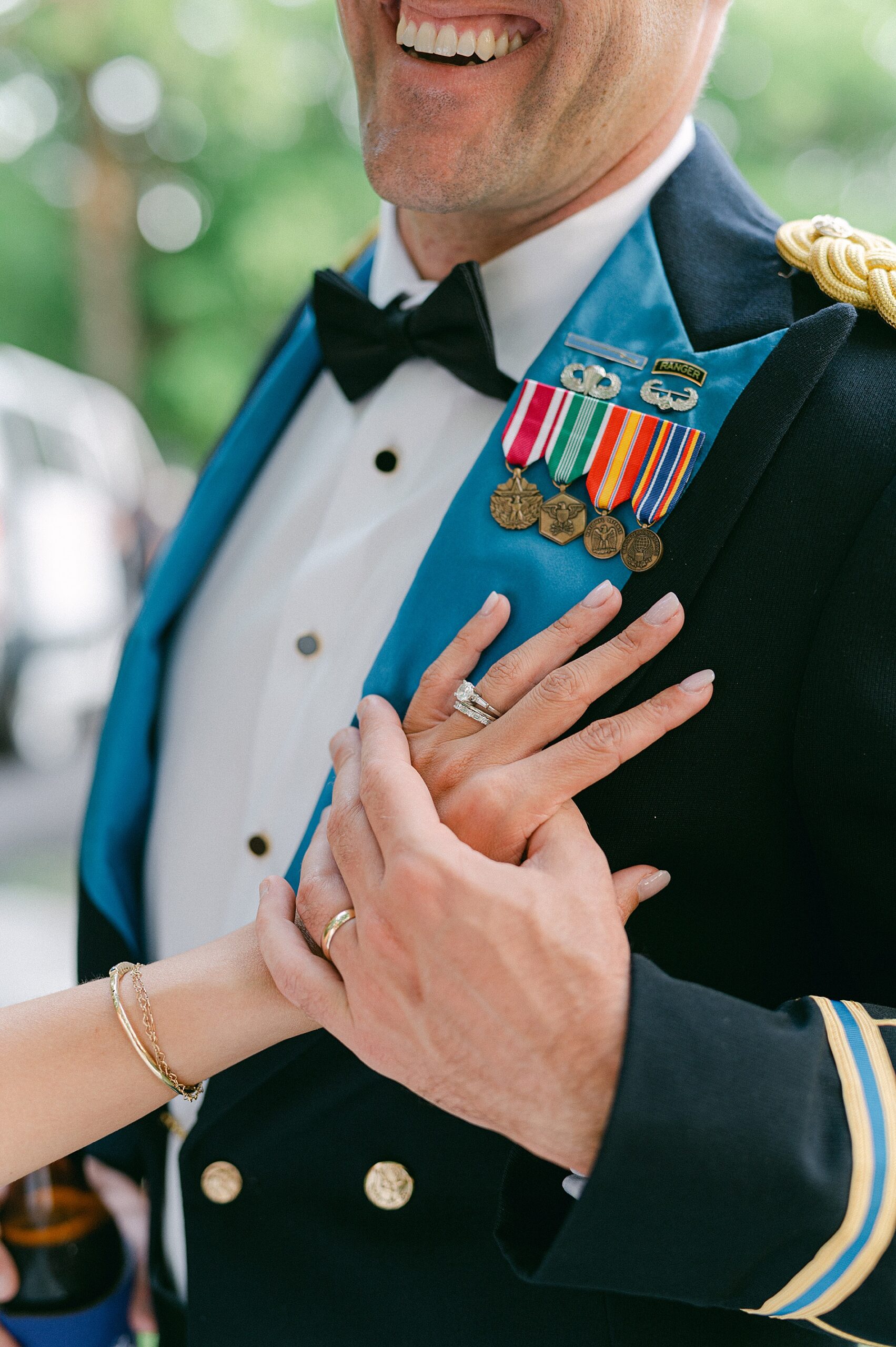 bride with her hand on groom's chest showing off wedding rings