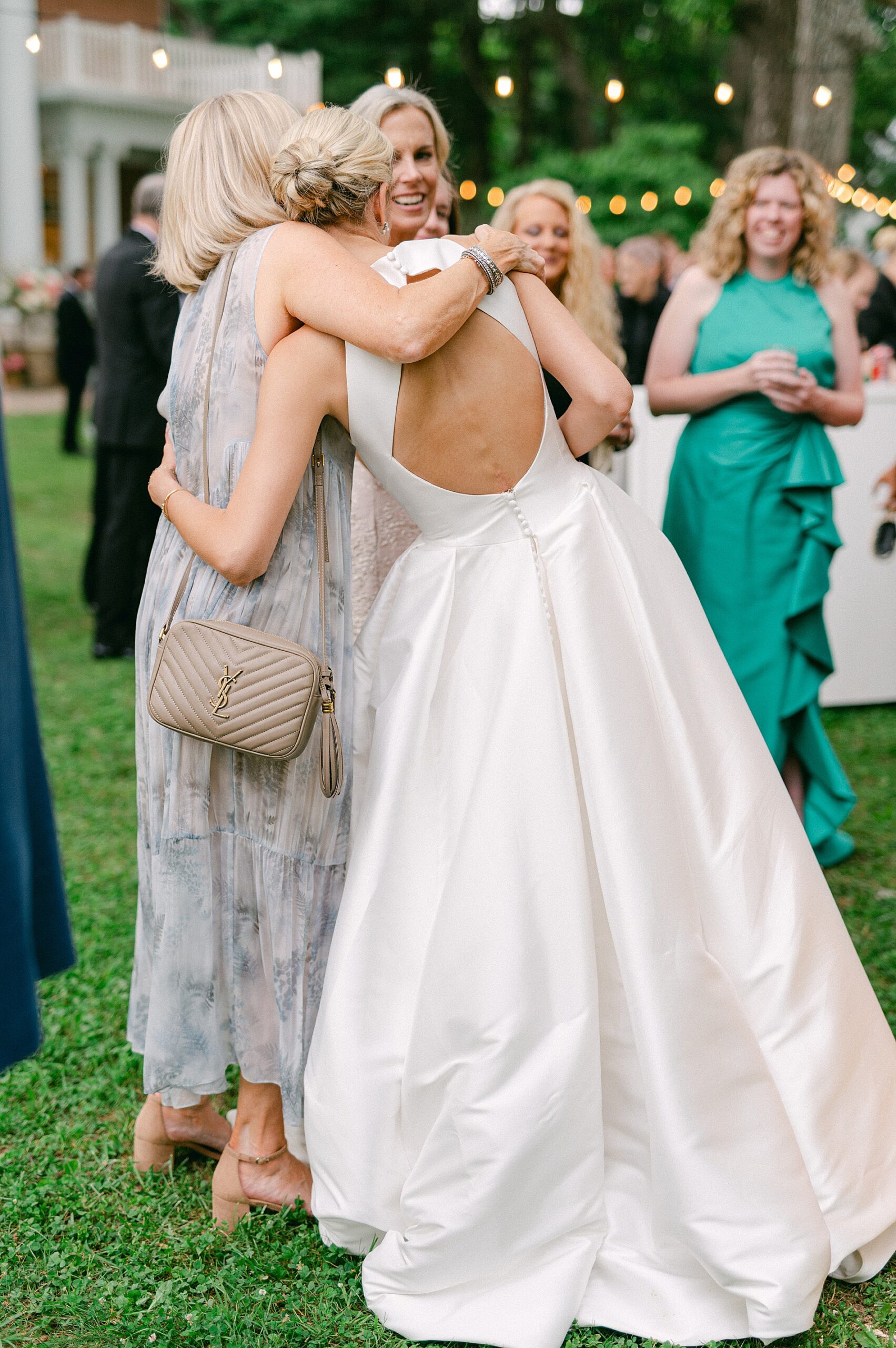 bride hugs wedding guest